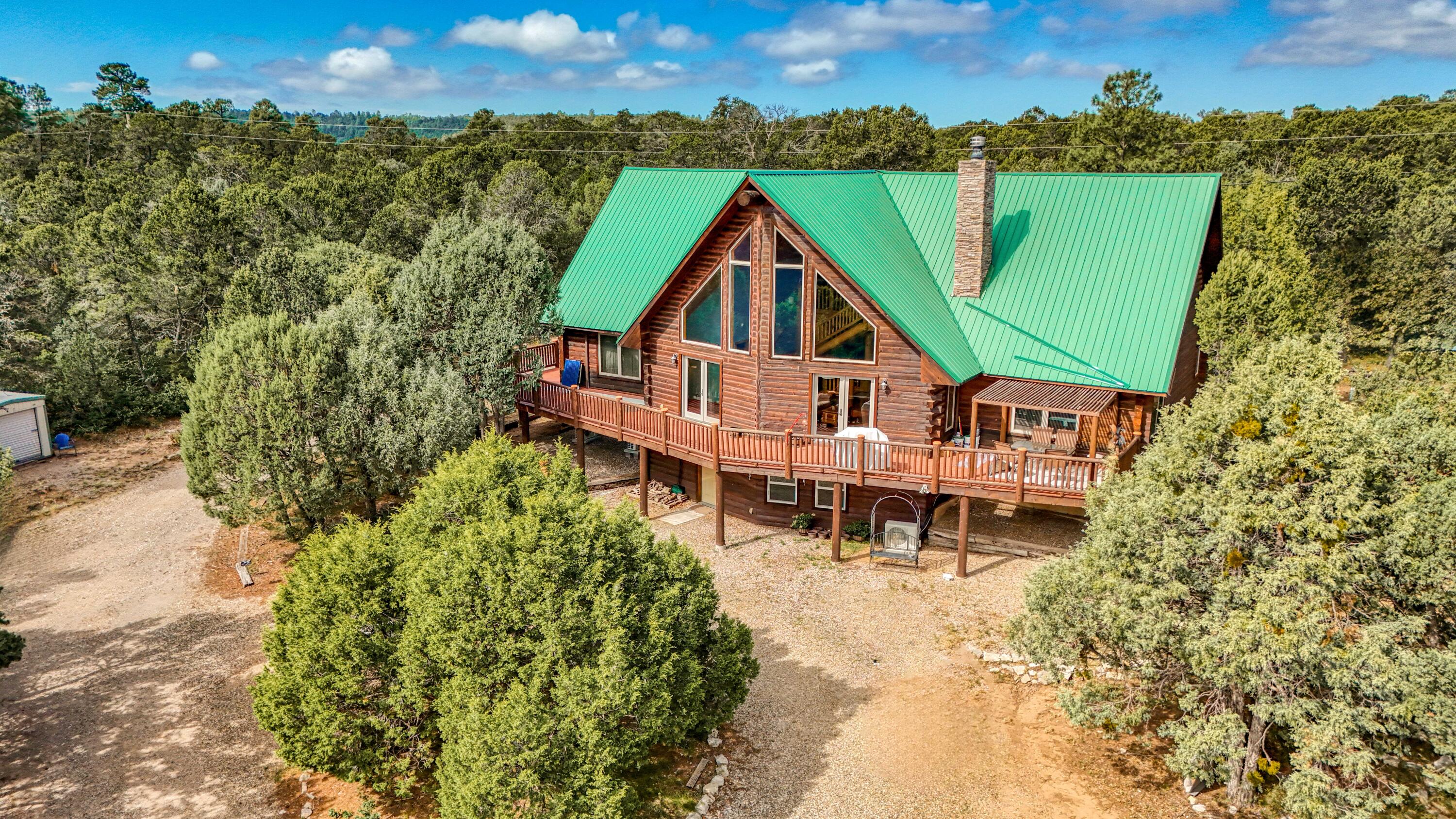 Welcome to Hidden Valley Ranch Subdivision! The dream home you've been looking for is here! We have all wanted a log home in the mountains & this one is waiting for you. This 3443 sq ft home is on 2.79 acres & has it all including exposed vigas, tongue & groove ceilings, a huge primary bedroom that goes out onto the wrap around deck, the bath is complete with a jetted tub & walk in shower. There's a loft that can be used as a bedroom or office & the downstairs area can be a 4th bedroom or game room the choices are endless. The radiant heat & fireplace are great during the winter months & the mini splits keep you cool in the summer. Updates include well pumps, shower tile, new cabana & deck replaced in 2021. Exterior includes 24x34 garage & 30x12 workshop & nice mature pine & pinion trees.