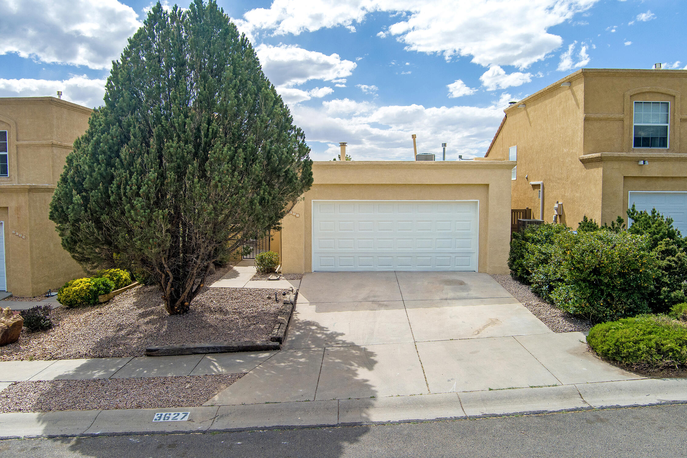 Beautifully updated home with no HOA or PID! Backs to Tramway with stunning city views. Upon entering the vaulted ceilings & high windows fill the space with natural light along with a gas fireplace to create a cozy, open family room. All-new kitchen boasts quartz counters, stainless appliances, gas stove, tile backsplash, pantry, and eat-in dining. Waterproof laminate flooring--no carpet! Recessed lighting and ceiling fans throughout. Recent upgrades include new HVAC, TPO roof, and  upgraded electrical. Fresh interior paint, new doors, baseboards, and lighting. Spacious primary suite with walk-in closet and updated bath featuring tiled shower with glass door. Front courtyard patio adds charm; backyard is perfect for soaking in beautiful Albuquerque sunsets. Call this home today!