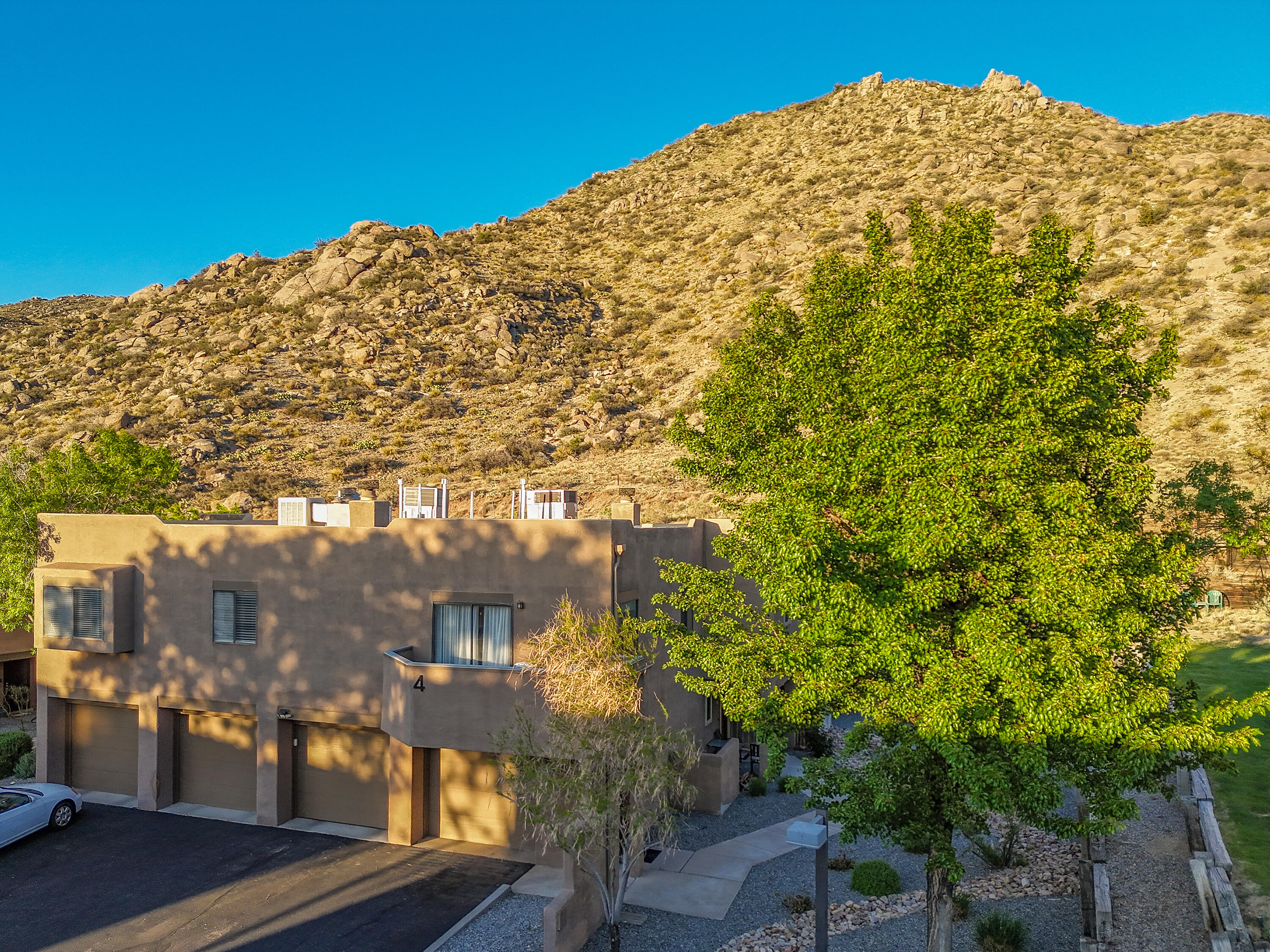 Wonderful community east of Tramway in the Foothills and just a short distance to the trails!  Views of the lower foothills from balcony and some peeks at sunset skies and northern mountains.   Cheerful 2nd story unit with lots of natural light, fireplace, open concept kitchen, living and dining room.  Two bedrooms and two bathrooms.   Primary has private bath.   1 car attached garage below with interior entrance.   HOA covers exterior, roof (owner says this unit roof is newer), streets, common area and water.