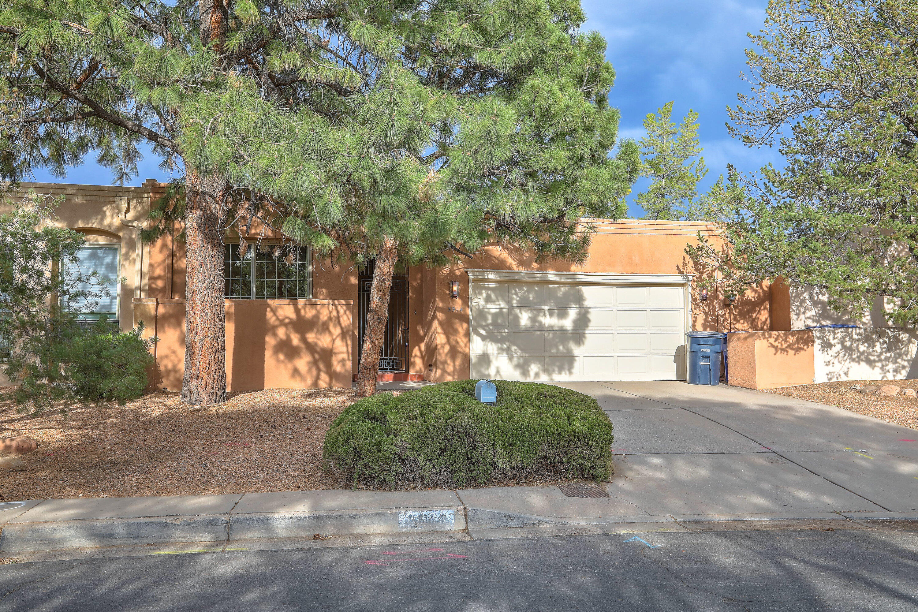 Charming Townhome in Prime NE Heights Location! Just steps from the Albuquerque Academy and Whole Foods, this light-filled 3-bedroom, 2-bath townhome offers comfort, convenience, and character. The spacious master suite provides a private retreat, while the adorable country kitchen adds warmth and charm to the heart of the home. A kiva fireplace creates the perfect ambiance for relaxing evenings. Enjoy the beautifully landscaped, quaint backyard -- ideal for entertaining or unwinding -- and take advantage of the oversized garage with plenty of storage. With abundant natural light and a layout that feels both cozy and functional, this home is for you!