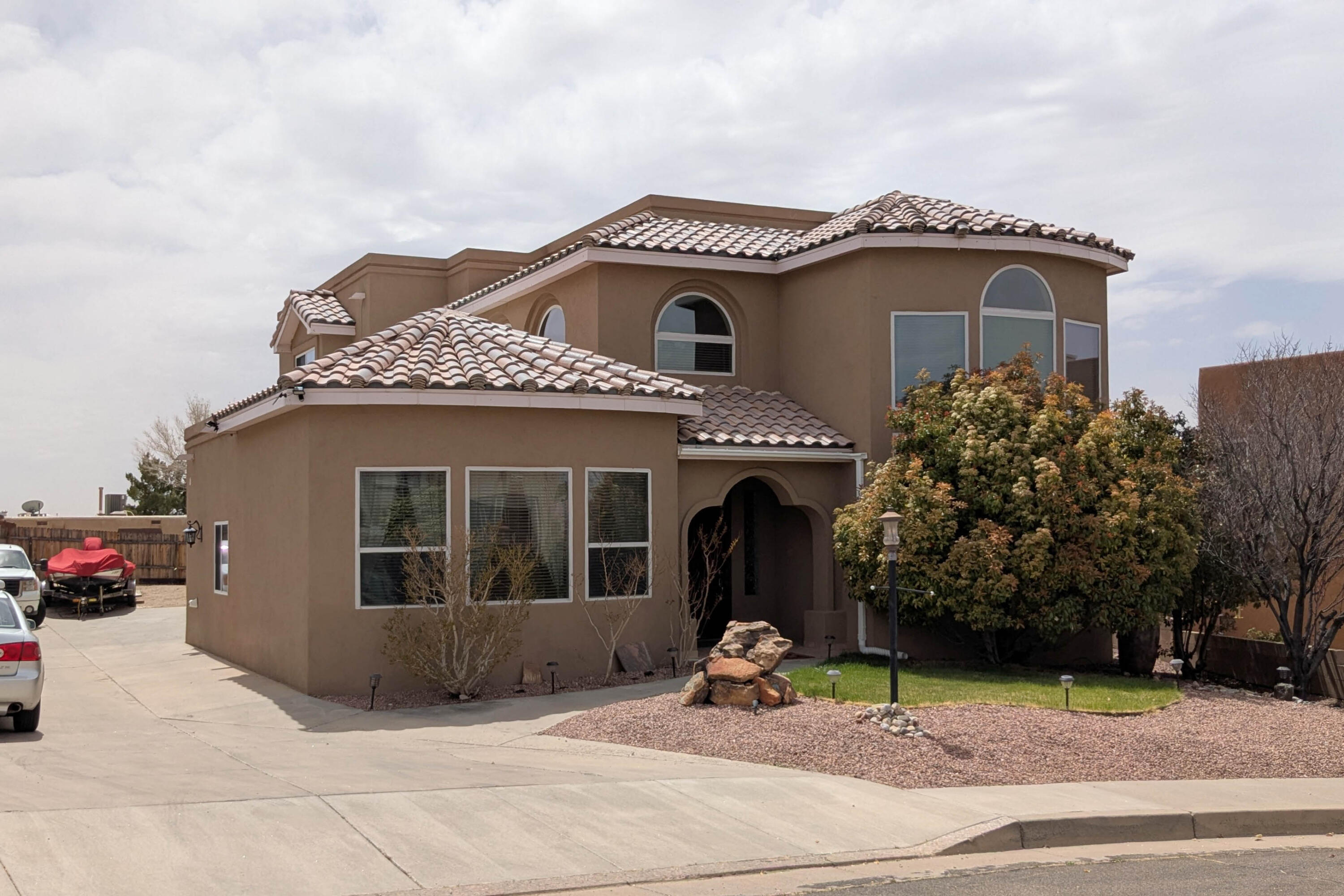 Beautiful custom home in the foothills w/stunning views of the Sandia Mountains & the City. This 3 bedroom with office and 4 bath home offers a spacious living room with 2 Master Bedrooms 1 downstairs and 1 upstairs and 20ft ceilings. Large loft w/fireplace & balcony. Two primary suites with walk-in closets & full baths w/jetted tubs. Third bedroom has on- suite bathroom & 2 walk-in- closets. Large laundry room with lots of storage & laundry sink. Kitchen with island, panty & breakfast area. Over 1000 sq. ft. 3 car oversized garage w/utility sink & AC.  Long driveway offers RV parking & RV hookup. 12x20 Storage Shed. New stucco in 2022. Private back yard offers a covered patio as well as open patio space & lush grass. Automatic sprinklers front & back.