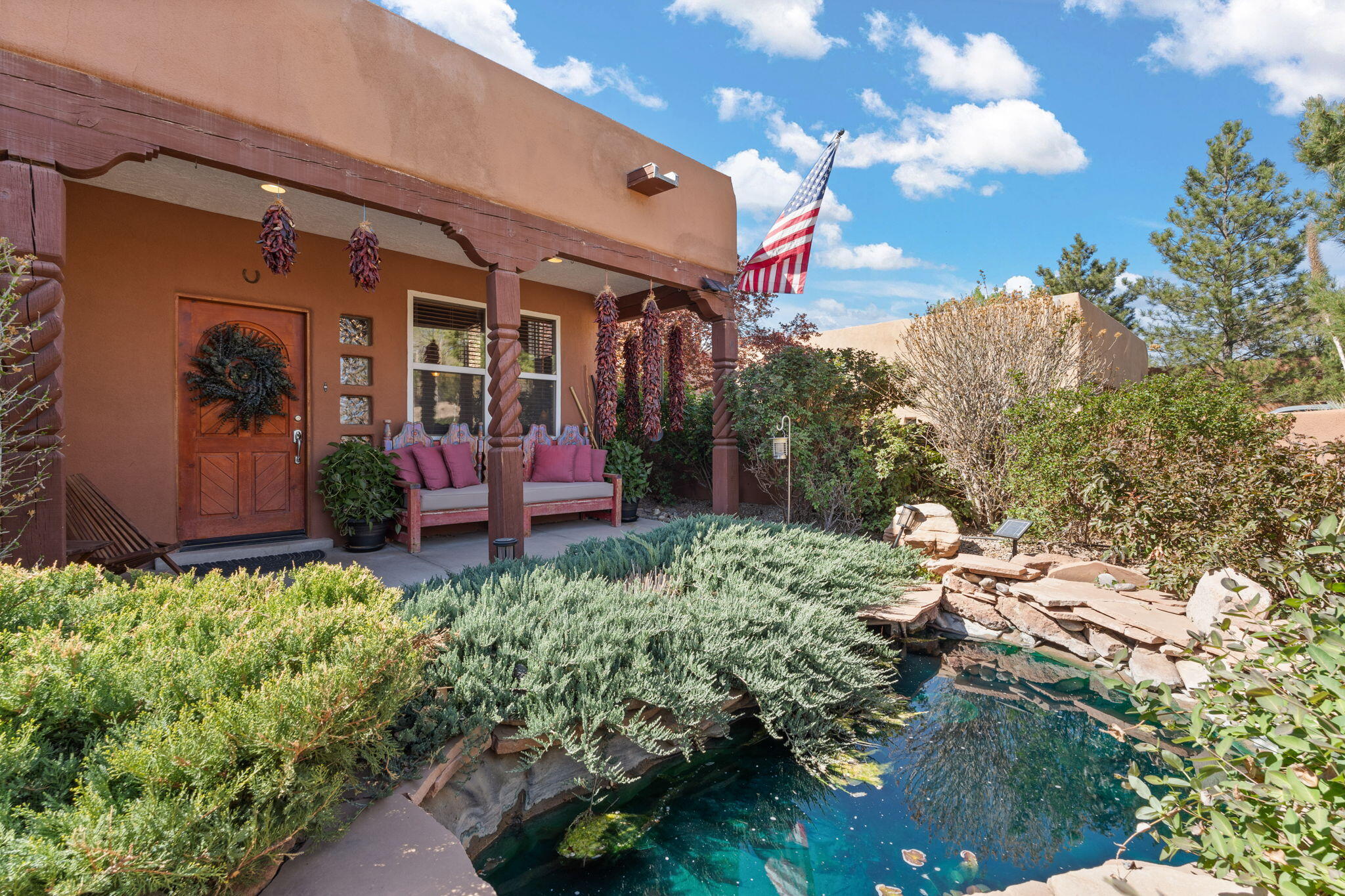 North Valley charm and modern luxury meet in this serene Los Ranchos oasis. You'll be greeted by a beautiful custom iron gate, lush roses and a koi-ready pond; inside you'll find an impressive T&G ceiling w/massive vigas spanning the entire length of the living room. The well-appointed kitchen features black stainless appliances, granite countertops, a walk-in pantry & plenty of cabinets. Polished concrete floors, radiant heating throughout, updated bathrooms & a private primary suite with custom shower, jetted tub, large walk-in closet and a trex-style deck with incredible views perfect for taking in the Balloon Fiesta and Sandia sunsets.