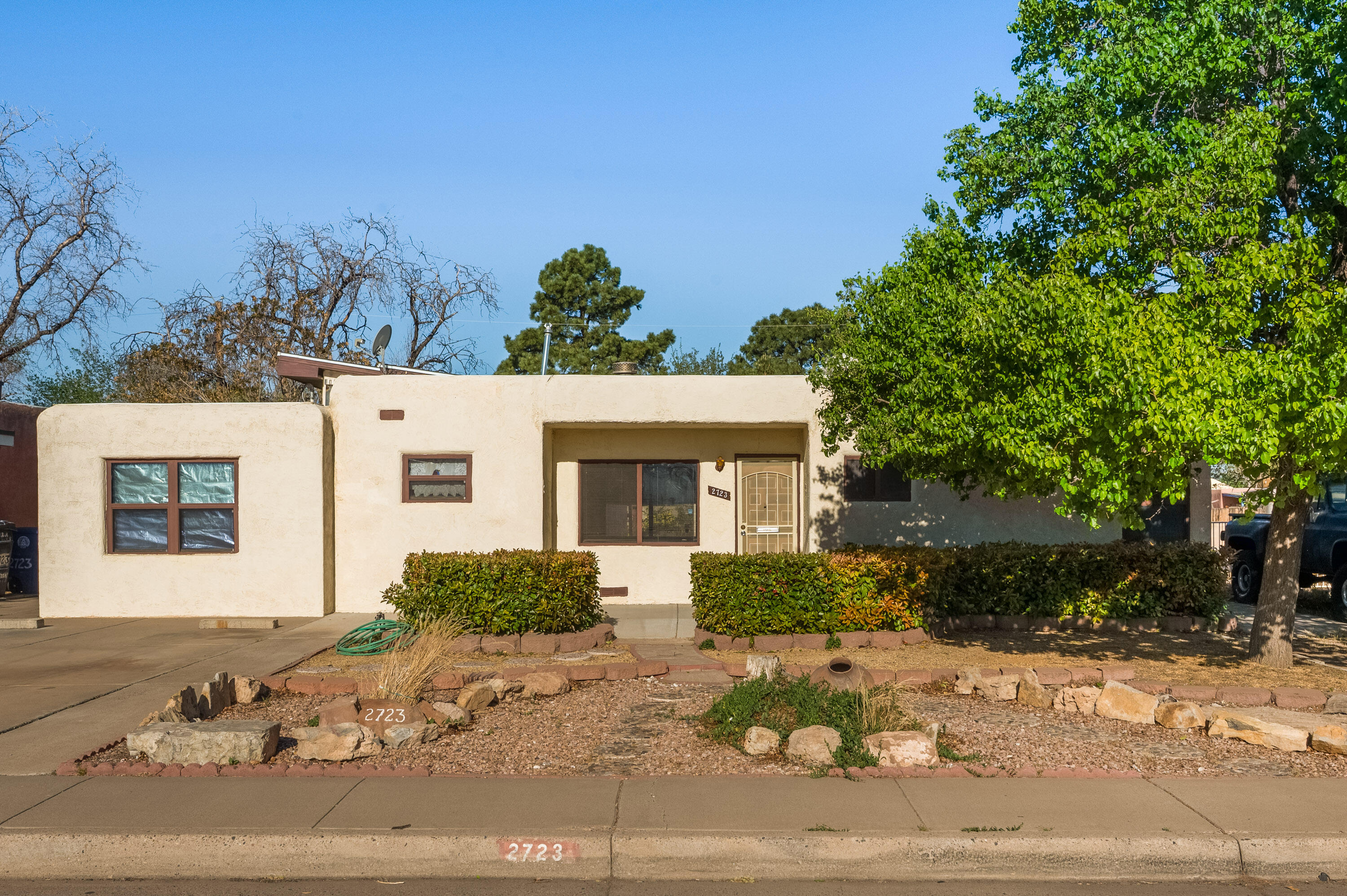 Great Potential in this home.  Main house is 2 bedroom/1 bath with a large living room with kiva fireplace and vaulted ceilings that has a mini split for AC/Heat.  The backyard has a Guest house with open floorplan, partial kitchen and 3/4 bath.  Has built in refrigerated AC/heater (heat pump).  Guest house has private entrance and parking for one.  Backyard access is available.  Potential income dwelling.  Well established neighborhood.
