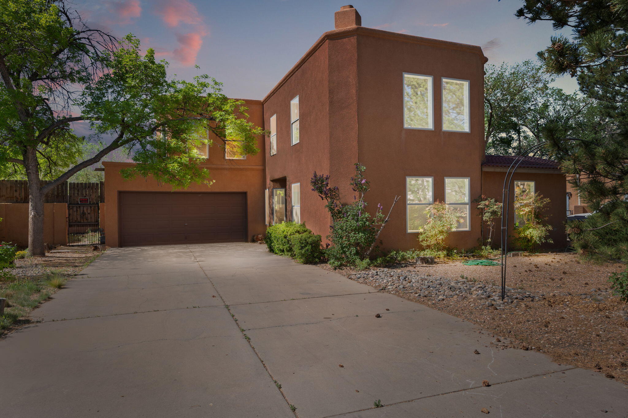 Beautifully maintained home nestled in the heart of the sought-after Dietz Farm neighborhood in Albuquerque's North Valley!  Offering 1,907sf with 3 bedrooms, 2 bathrooms, a loft and 2 car garage. Wonderful living area with laminate wood look floors, soaring ceilings and a kiva fireplace. Impressive kitchen with sleek white cabinetry, backsplash, stainless steel gas range, microwave, dishwasher and breakfast bar. Dining space right off of the kitchen. First floor owners suite with outside access, a skylight and private bath. Additional first floor guest room. Upstairs find a loft area with fireplace and an additional guest room. Fully walled backyard with open patio!  Within walking distance of great restaurants and shopping!