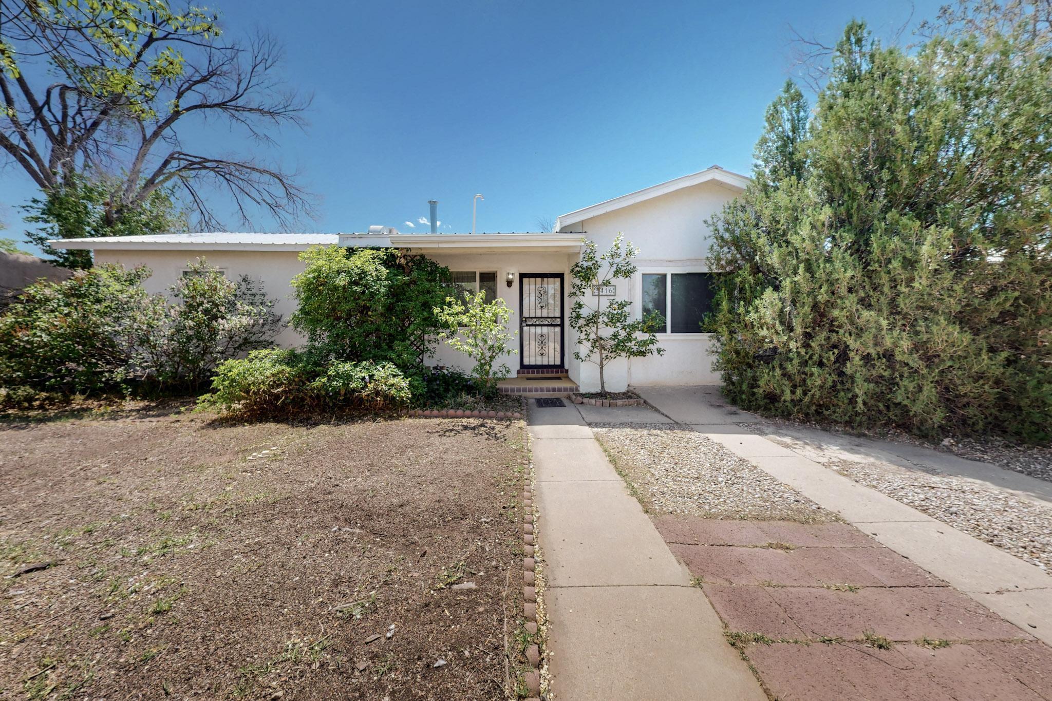 Located near UNM and the New Mexico Fair Grounds is a very nice, well maintained home ready and waiting for a new owner. Welcoming family and friends, is the nicely appointed front yard.  The home has two bedrooms, one with a full bath and a good sized owner suite with a 3/4 bath and a walk in closet.  The great sized living room  provides a nice space for a formal dining area.  The family room has a cozy fireplace.  This room is a perfect place to watch television or play family games. The back yard is very spacious, a perfect place to entertain, or plant a garden in the raised garden beds.  There are two store rooms, one that could be a nice little studio.  This is a beautiful, affordable  home, in a nice neighborhood. Ready for a new owner