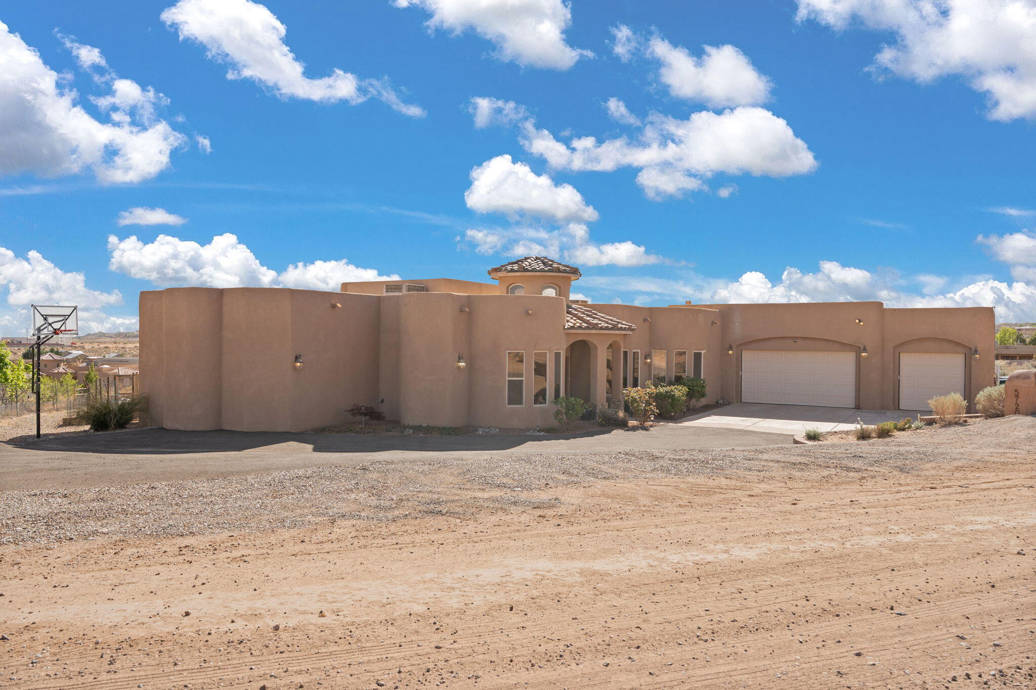 Nestled on a generous half-acre lot in Rio Rancho, this exceptional property offers Sandia Mountain views and a unique blend of space, versatility, and modern comfort. Car enthusiasts and hobbyists will be thrilled with the oversized 3-car garage, complete with extended depth for all your stored gear. A game room/hobby room within the garage structure is temperature controlled for your favorite past-time.  Additional work-shop storage room and separate outdoor shed provide even more hobby/storage opportunity. This home goes beyond the ordinary with a fantastic, attached casita featuring its own kitchen, living room, and ensuite bedroom - perfect for multi-generational living, guests, or potential rental income.