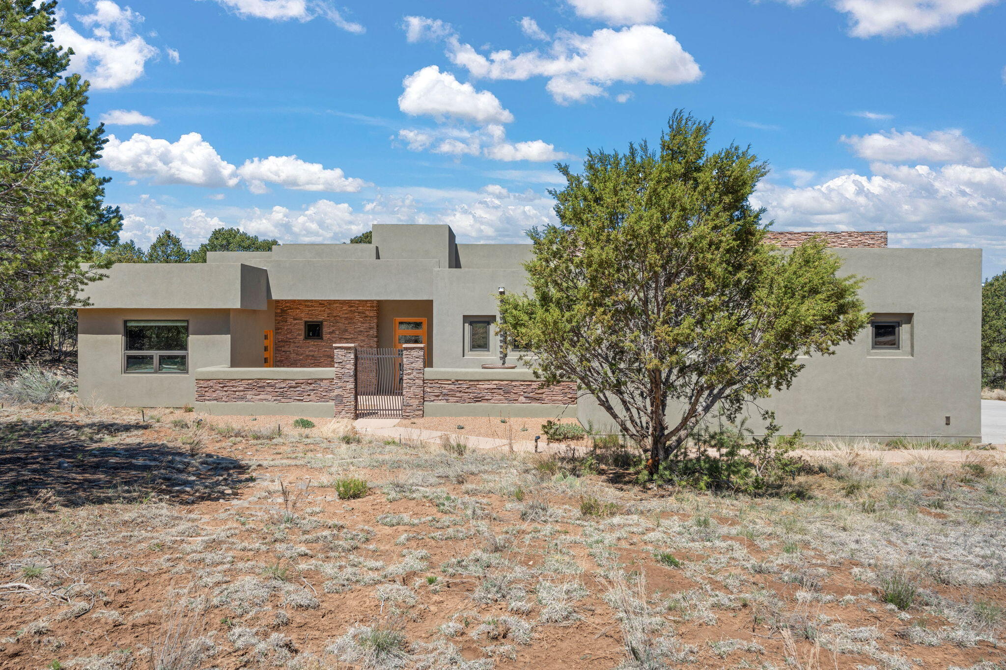 Nestled on 2 acres in the gated Nature Pointe community, this mountain home blends privacy & modern elegance w/ energy efficiency! Certified Build Green NM Gold, it features an owned 4.2 kW solar system & Pella low E triple-pane windows-save thousands on utilities! Expansive windows fill the space w/ natural light & the kitchen showcases granite countertops, stainless Bosch appliances & sleek cabinetry. Living room features a pellet stove, while the primary suite offers a luxurious bathroom w/ steam shower.Highlights include an in-law suite w/ separate entrance, a 1221 sq ft garage w/ 30 ft RV GARAGE/SHOP, epoxy floors, & insulated doors.Home is on Entranosa community water & walking distance from community center w/ a gym,pool & pickle ball courts;just 20 mins from ABQ. Rare opportunity!