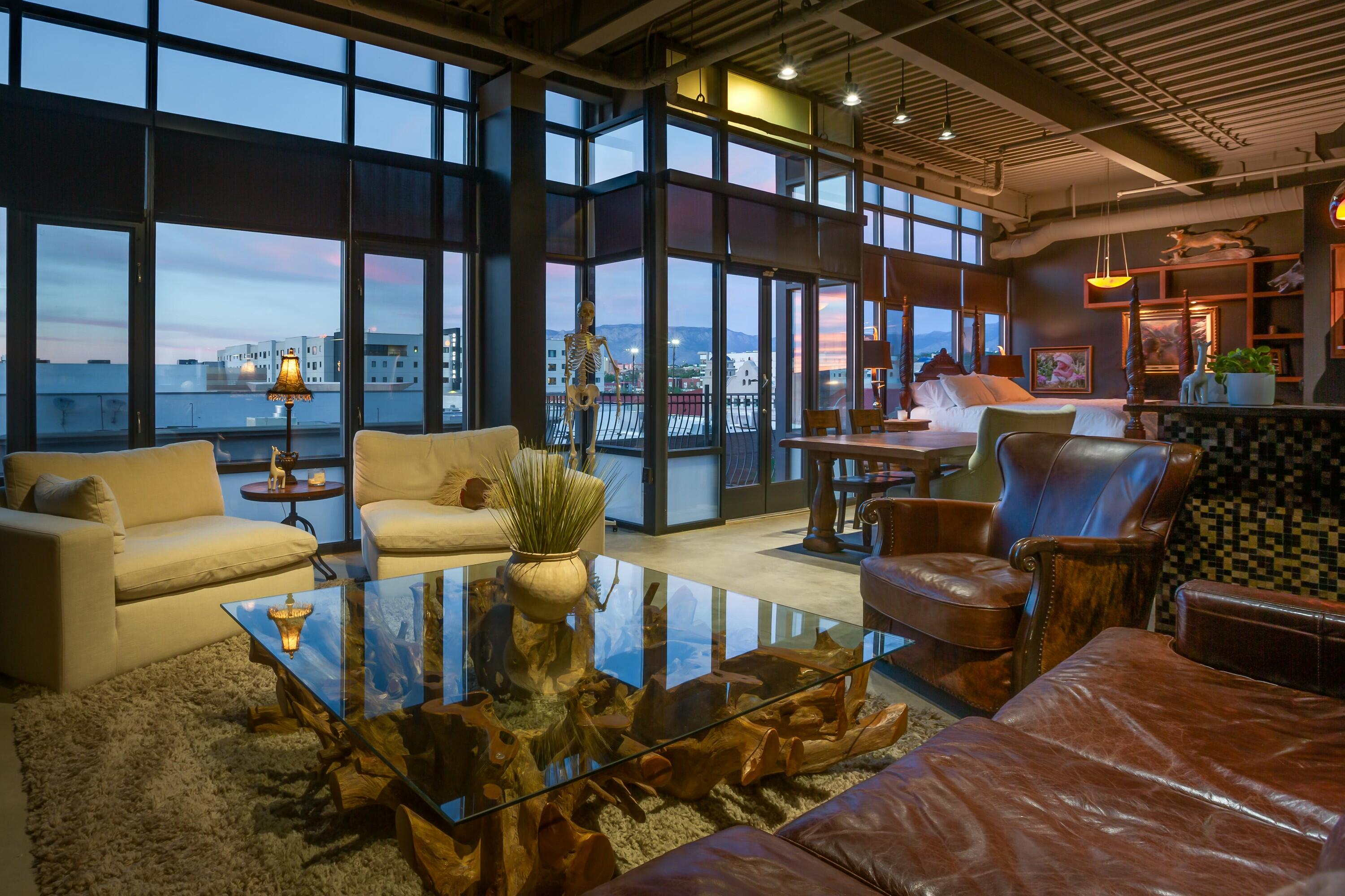 Live at the center of it all in this stylish and spacious 2-bedroom, 2-bath + powder room condo in the heart of downtown Albuquerque. Located in well-maintained 100 Gold Avenue building, this 1,538 sq ft unit offers contemporary design, floor-to-ceiling windows, and industrial concrete flooring throughout.The open kitchen features a bar counter ideal for entertaining, flowing seamlessly into the living and dining areas--perfect for hosting or simply enjoying the urban energy from your own space. Each bedroom includes its own en suite full bath, and the powder room adds thoughtful convenience for guests.Whether you're an urban dweller, first-time buyer, or investor, Unit 404 delivers space, location, and contemporary appeal in one exceptional downtown address.
