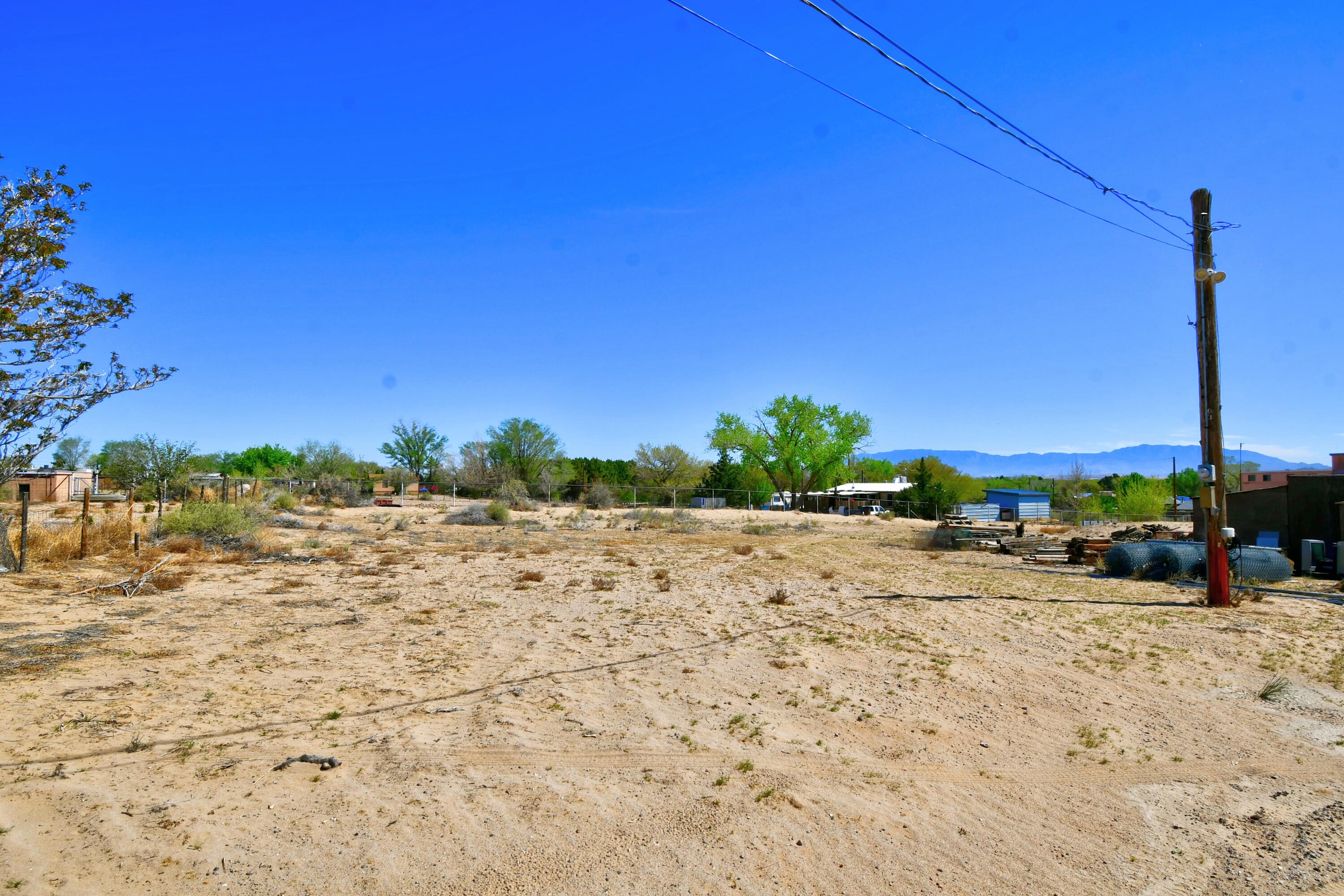 MOBILE HOME ON PROPERTY IS CHATTEL AND CONVEYS IN ITS CURRENT CONDITION. Electricity on pole in lot, private 200-ft well, city sewer available for hook up. Great views. Sale INCLUDES a well maintained 1973 14 x 76' Wayside mobile home with three beds/2 baths and lots of amenities like a metal roof installed in 2023. 3 storage sheds and a well house totaling 384 sf. Plenty of room for three or four horses. Fully fenced. 8 x 8 ft chainlink front gate. Cattle gate in rear opens to irrigation ditch: water available for irrigation for a fee. Close to I-25, fire department, and schools.
