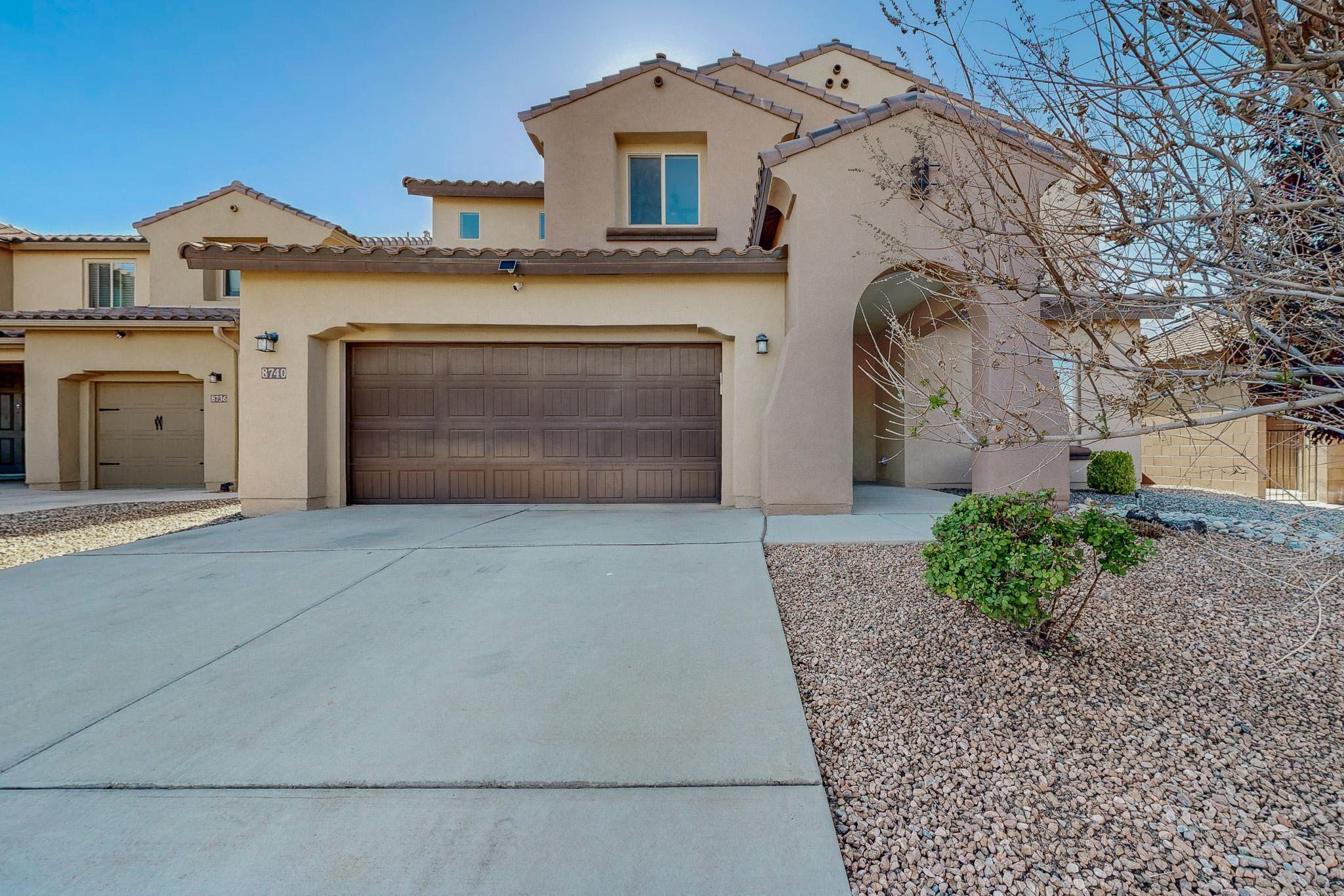 Pulte home at 8740 Abierto Vista Cir, Albuquerque, NM, ready for you! A covered front porch and soaring foyer ceilings greet you. To the right, a versatile room serves as a sitting room, office, or gym. The spacious family room flows into a large kitchen and living area, ideal for entertaining or family time. Features granite countertops, black appliances, pantry, dining area, and four upstairs bedrooms, including an owner's suite with double-sink vanity, separate tub/shower. Includes a washer/dryer which are located upstairs for convenience. 3-car tandem garage, covered patio, and landscaped front/back yards.