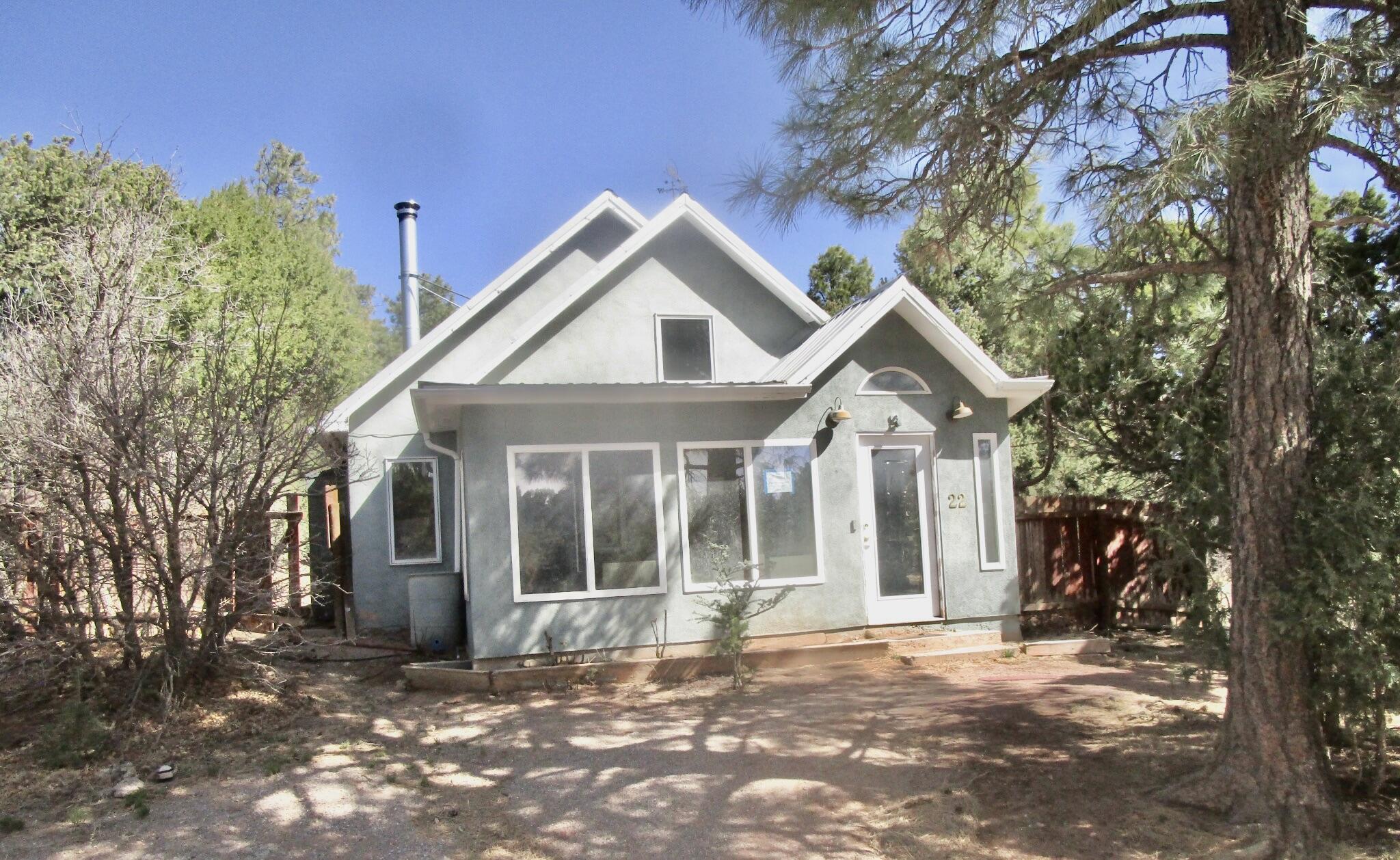 HIDDEN GEM ALERT! Welcome to this charming single-family home tucked away in the peaceful and highly desirable mountains of Tijeras. This property offers a cozy yet functional layout, featuring 2 bedrooms, a versatile loft, 13/4 bathrooms, a sunroom, & a spacious yard perfect for outdoor living.Inside, you'll find a large, open living room ideal for relaxing or entertaining, while the quiet street and beautiful vista views create a serene setting perfect for peaceful walks and enjoying nature. Whether you're looking for a mountain retreat or an investment opportunity, this home is full of potential.Please note: the property is being sold AS-IS, with no warranties or guarantees expressed or implied. Buyers are strongly encouraged to conduct their own inspections.  CASH-only purchase!