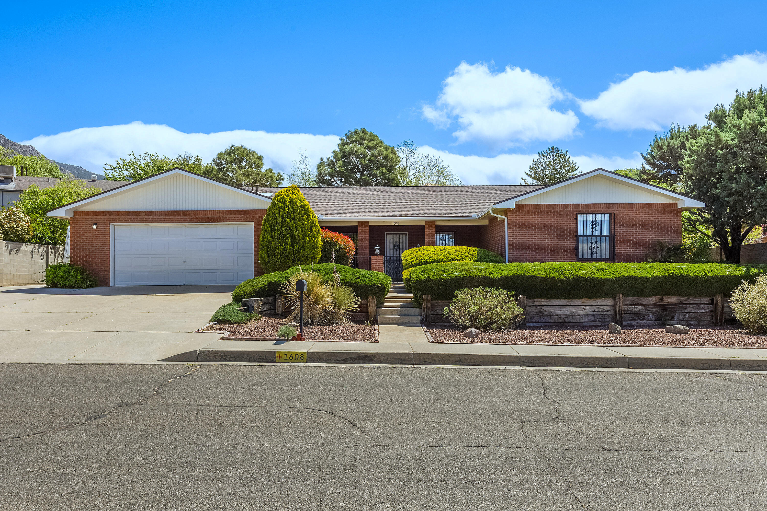 Custom Brick Single-story Home in the Foothills of the Sandia Mountains. Located on the cooler side of ABQ on a beautifully maintained .23-acre lot. w 3 generous bedrooms, 2 large baths, a kitchen w new counter tops and back splash, breakfast nook, family dining room, refreshed paint and new floors throughout, cozy family room w wood-burning fireplace, oversized 2-car garage with shelving and storage, plus RV parking with electrical hook-up and sewer dump. All kitchen appliances will be conveyed. No HOA. Just a 5-minute walk to Embudo Canyon trails--perfect for outdoor lovers!