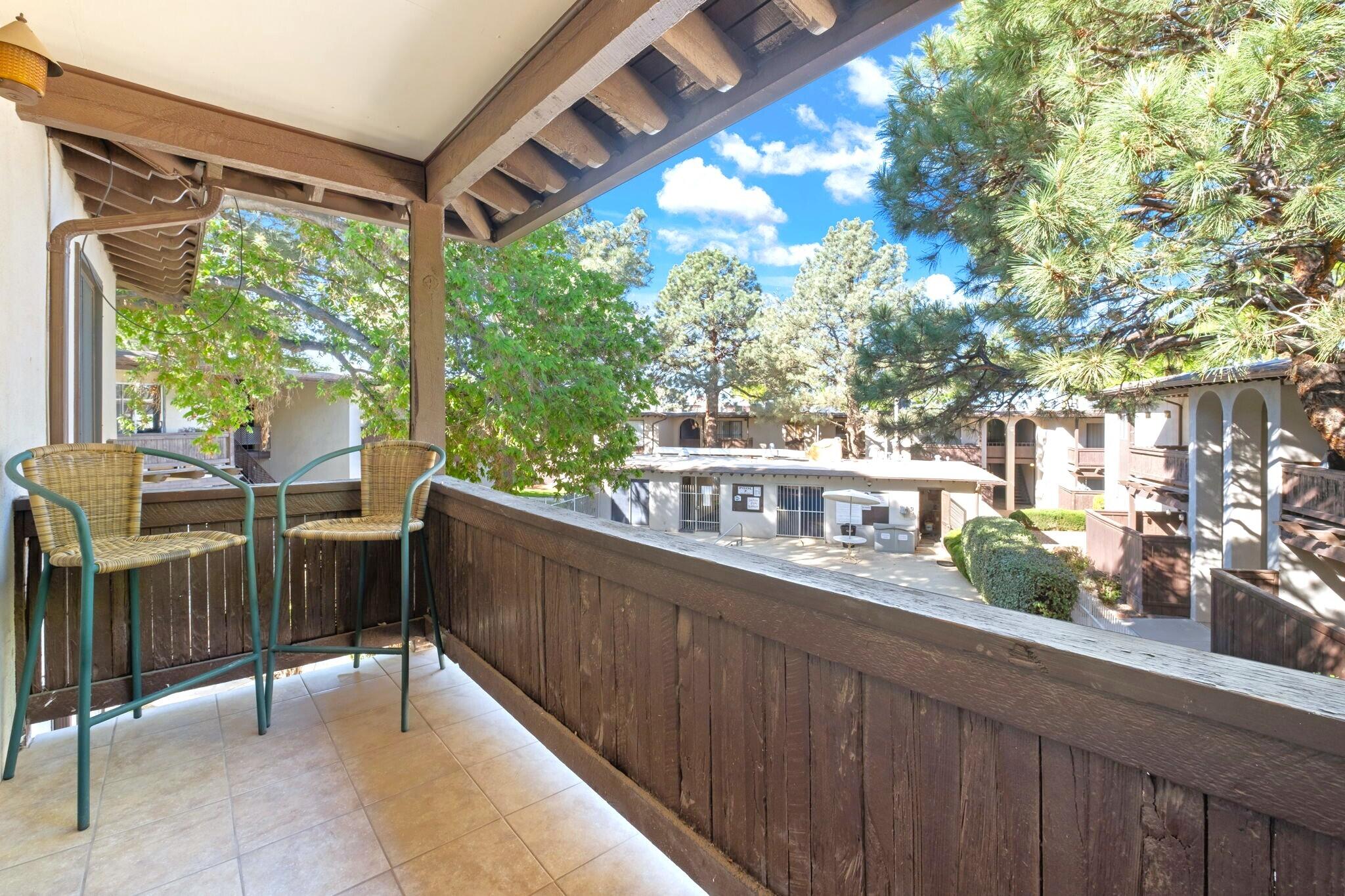 Updated Condo overlooking the pool! 7%-9% Potential CAP Rate Ideal investment in a coveted area of ABQ's Uptown! This 1-Bed 1-Bath condo w/ spacious walk-in closet overlooks the pool & courtyard. Updates such as granite counter tops, newer refrigerated air/central heat combo unit, new Classic Acacia vinyl plank flooring, new ceiling fans throughout, new ceramic tiles & new screen door on balcony! HOA covers all utilities, property taxes, grounds maintenance, & on-site security. Carport parking space & storage locker convey. Community has all year around indoor pool / hot tub, 3 outdoor pools, on-site laundry facility, clubhouse, & more! Catty corner to Winrock Mall, Regal Cinema, Chuze Fitness, & fashionista shops - Michael Kors, Banana Republic, Chico's, etc!