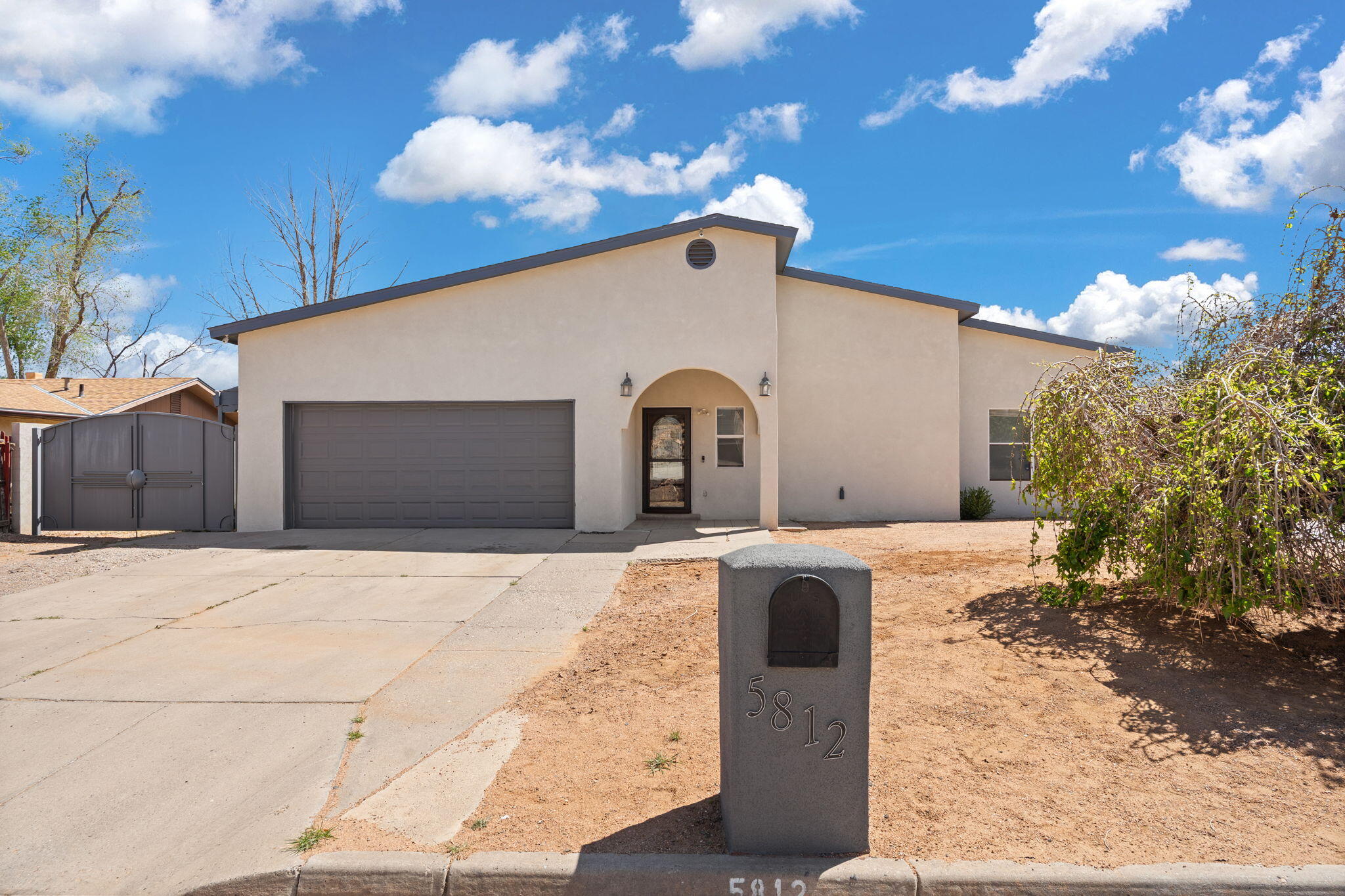 Located in the Paradise Hills District, this home offers a large .21 acre lot with backyard access.  Excellent for anyone looking for additional parking space.  The exterior styling and custom gates give it a modern vibe with a Zia symbol on the gates for that NM touch.  The home also showcases custom tile flooring in the main living areas and kitchen.  Additionally, the stainless steel appliances will also convey.  Don't delay, schedule your showing today!