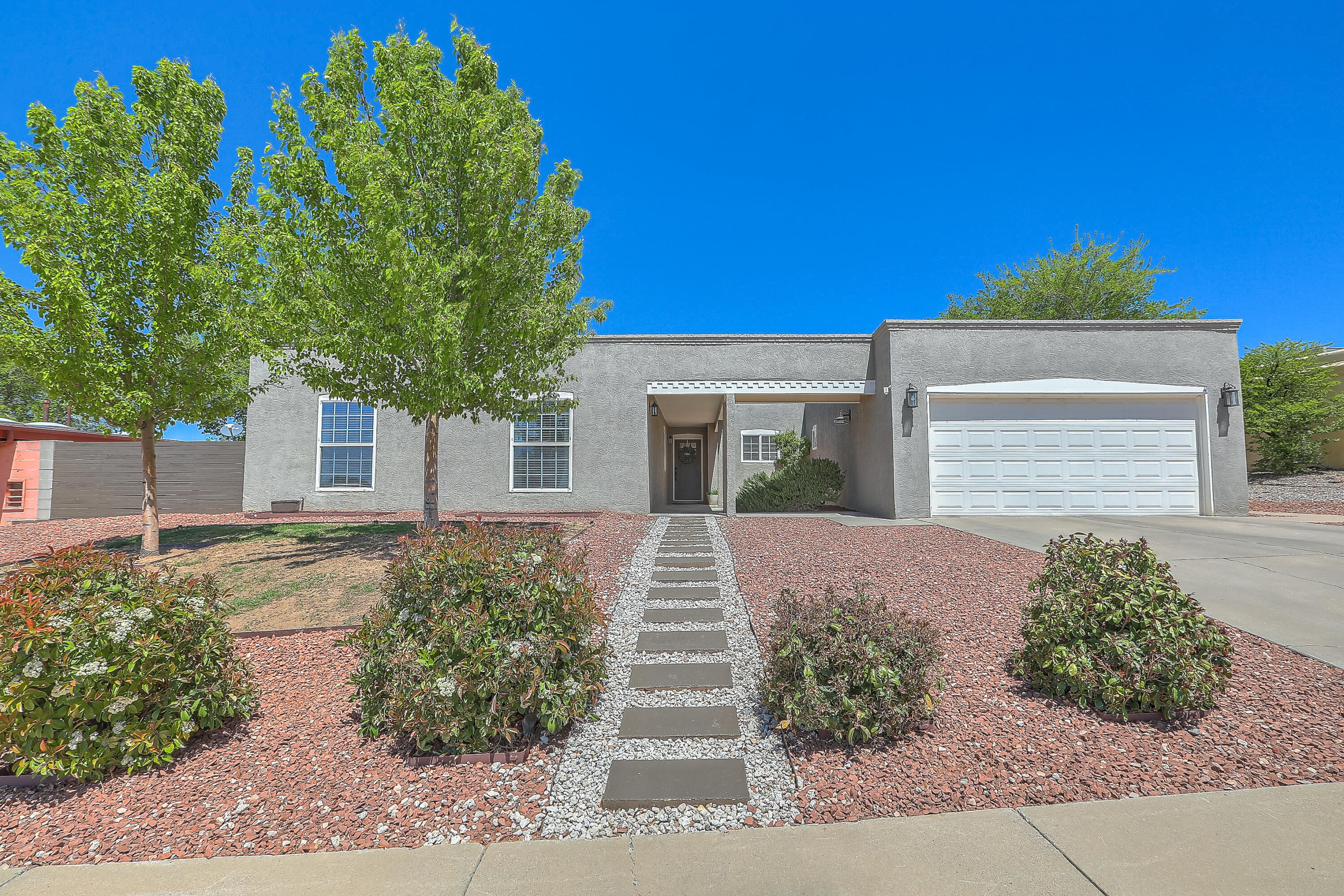 This recently updated home offers four -- potentially five -- spacious bedrooms and sits on a generous 0.22-acre lot in the desirable far Northeast Heights. Inside, you'll find an open-concept great room that seamlessly connects to a modern kitchen, complete with upgraded cabinets and countertops. Newer flooring enhances the expansive multiple living areas and well-sized bedrooms. The oversized two-car garage provides ample storage and parking. The standout feature is the huge primary suite, which includes a luxurious soaking tub, double vanity, and custom walk-in shower. This home combines comfort, space, and style in a sought-after location.