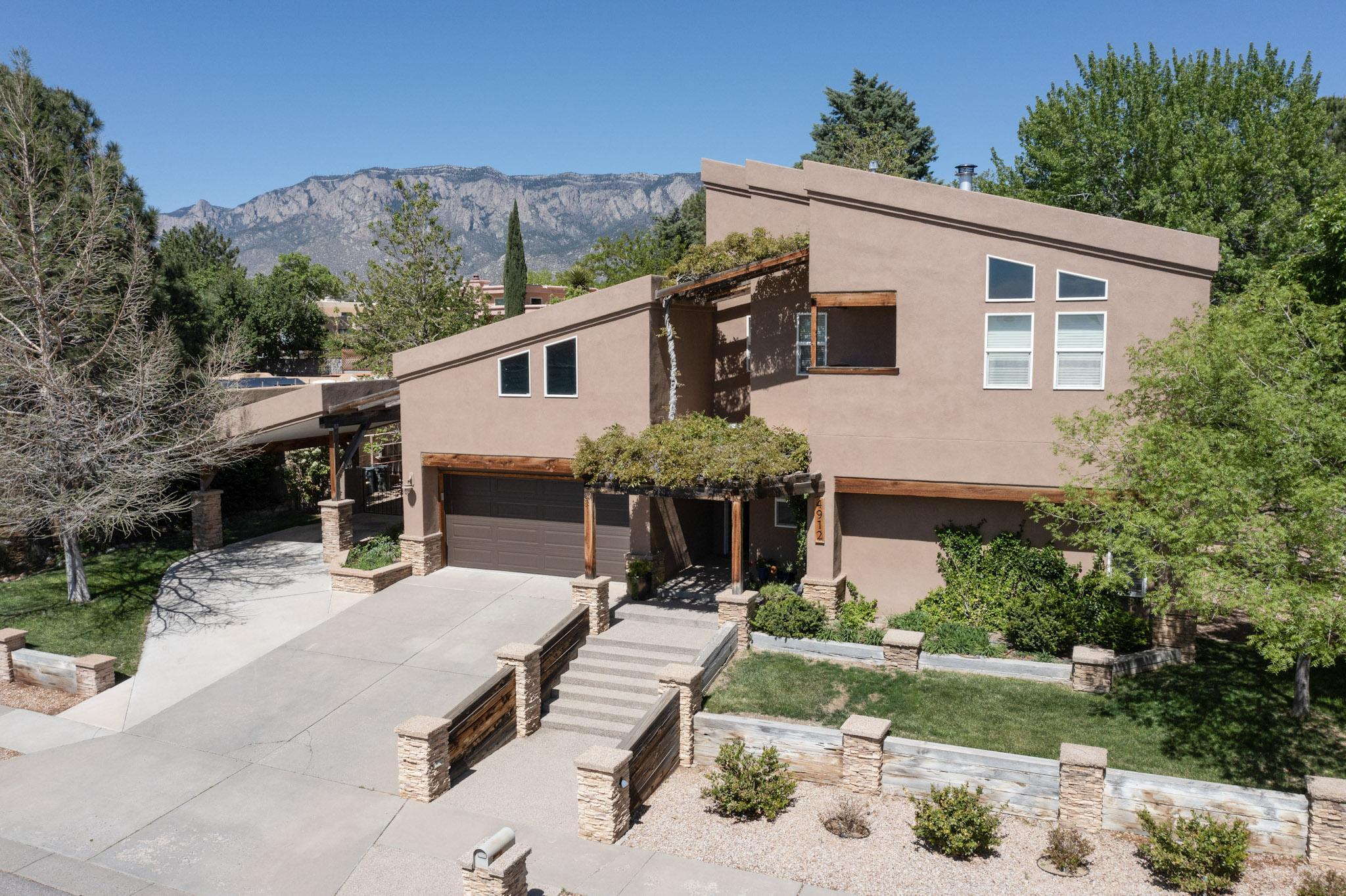 Welcome to Glenwood Hills! As a student of architecture and lifetime builder, the owner purchased this home with an eye toward transforming it into something special. Form follows function here, and beauty has not been sacrificed in the endeavor. The second floor addition features a primary bedroom that leaves nothing to be desired, and all four bedrooms have been amended to include fully functioning bathrooms. The main floor boasts an open living space, and a large kitchen and pantry designed to make everyday meal preparation for the family, as well as entertaining friends, a breeze. An attached garden room easily holds all you'll need to maintain the spectacular landscape, which features terraced gardens, a covered dining area and a water feature that will calm your senses daily.