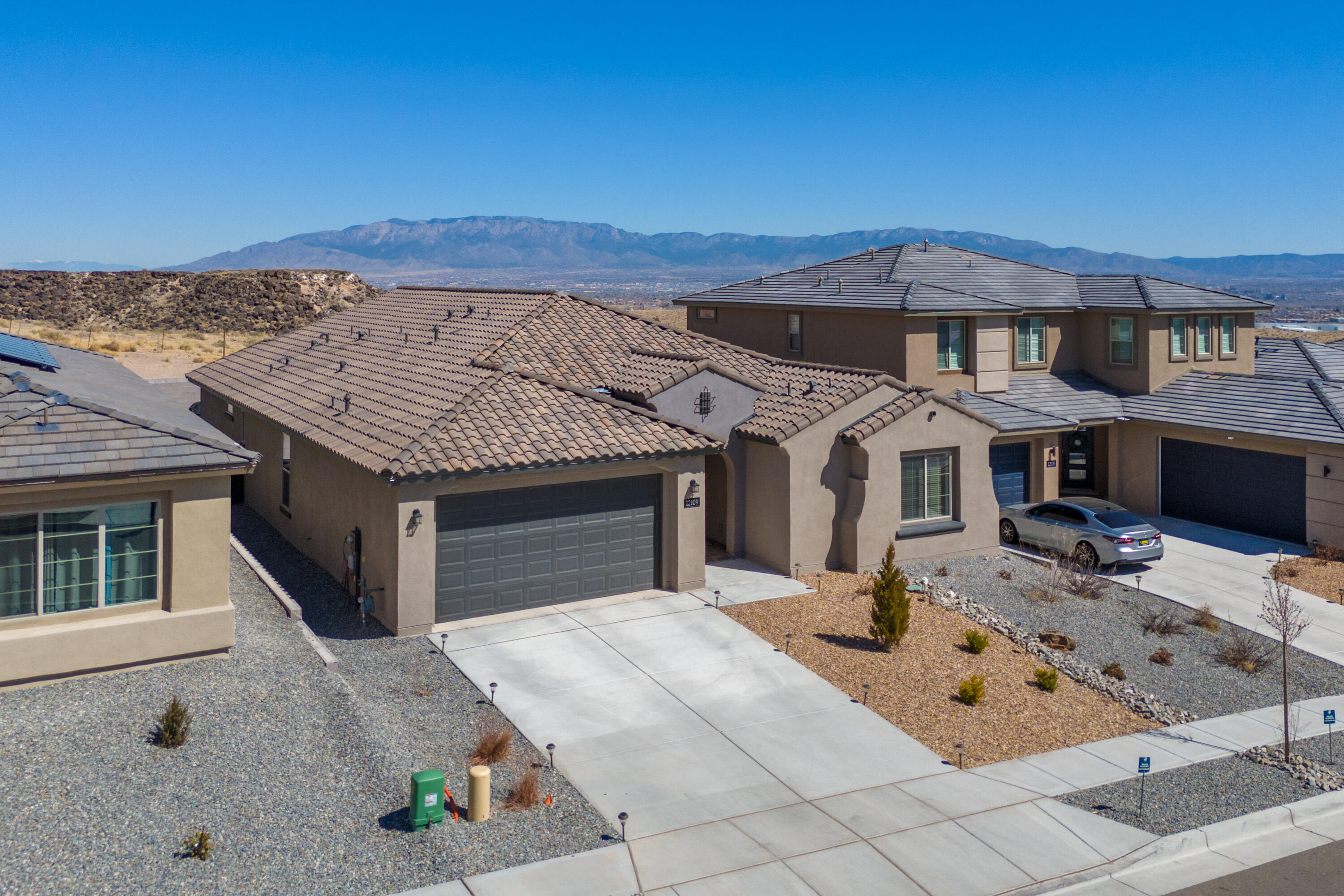 This home has it all: Parklane model backed up to Petroglyphs National Monument with incredible views of the Sandia's during the day & beautiful stars & city lights at night. Ownership pride shows in this immaculate, well-cared-for, open floor concept. Beautiful LVP & neutral colors throughout make this home move-in ready. Bright kitchen perfect for cooking & hosting. Kitchen includes granite countertops, elegant lighting, a built-in cooktop, pendant hood, wall oven and microwave, abundant cabinets & pantry. Large Primary Suite includes spacious walk-in closet & double sink in 3/4 bath. Whether you prefer watching the beautiful sunrise as you enjoy your coffee in the morning or sharing a serene evening sunset of the Sandia Mountains while entertaining friends & family, this home has it al