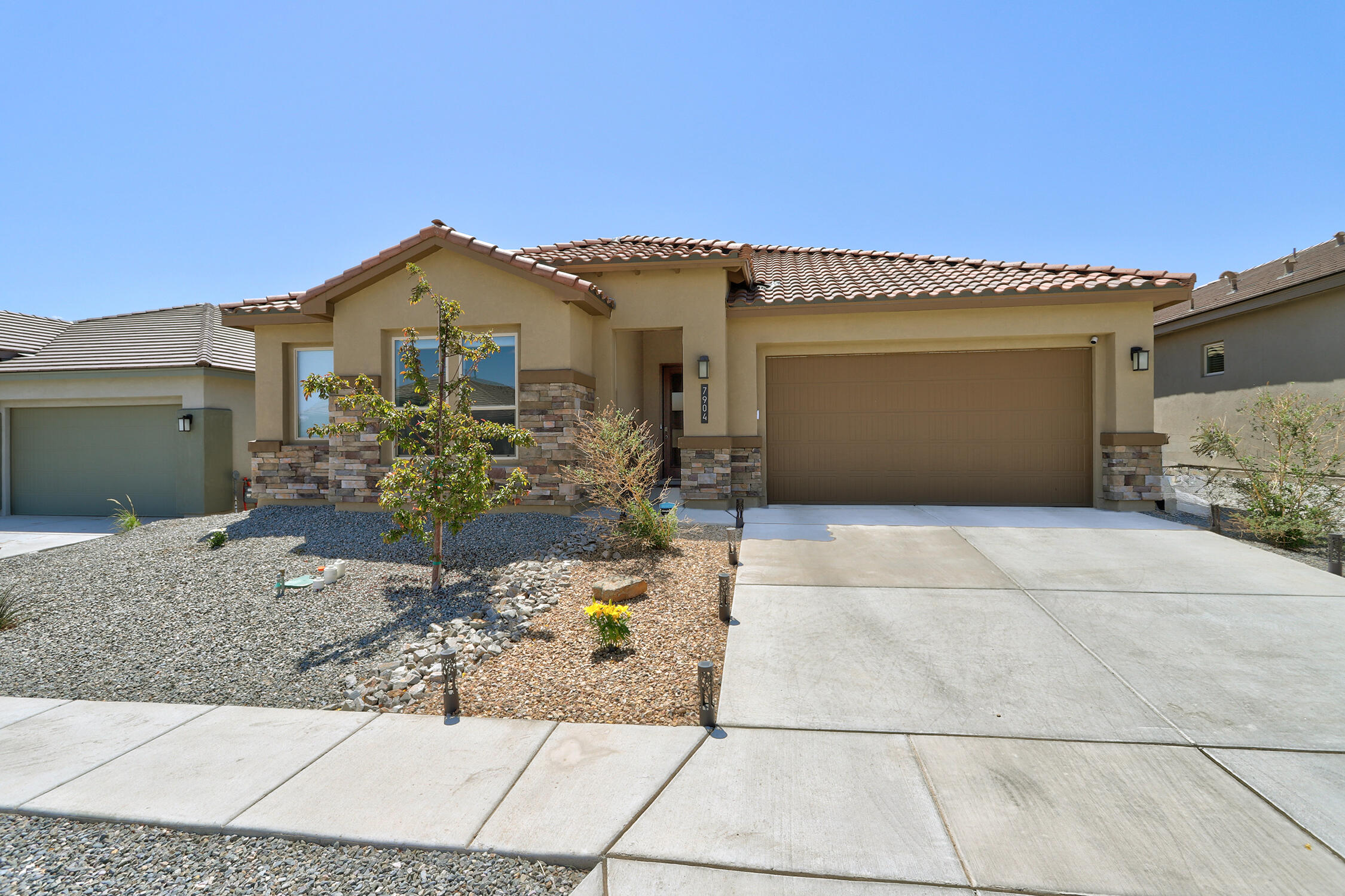 Discover your dream home in beautiful Catalonia! This like-new residence boasts 4 spacious bedrooms and a versatile office/flex space, perfectly designed for modern living. The 3 car tandem garage provides ample storage and convenience. Step outside to the impressive outdoor living space featuring a landscaped backyard with low-maintenance turf, elegant flagstone walk way, and a cozy covered patio - ideal for entertaining or relaxing on sunny afternoons. With a charming touch of stone veneer exterior and wood-look tile flooring throughout the high traffic areas, this home effortlessly combines style and functionality. Plus, enjoy the convenience of nearby schools, parks, and trails, making it an excellent choice for any home owner and outdoor enthusiasts alike!