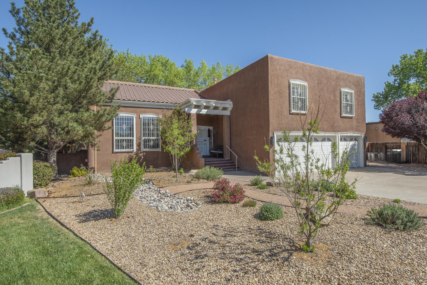 Noted local builder Jeff Leslie constructed this delightful tri-level on an oversized cul-de-sac lot in prestigious Thomas Village, part of the Near North Valley! An excellent floorplan allows for spacious public and private spaces; design details include vaulted ceiling, beams, dintil molding, granite counters and subway tile backsplashes. Formal living & dining, kitchen with breakfast nook, and family room with fireplace & wet bar. Four roomy bedrooms upstairs includes the primary suite with balcony & luxury bath. Professional low-water front yard landscaping + verdant green backyard with gazebo, covered patio & storage building. TPO roof new in 2024; carpet new in 2025. Three car garage + backyard access. Popular location with easy access to the Bosque, Old Town, Downtown and I-40.
