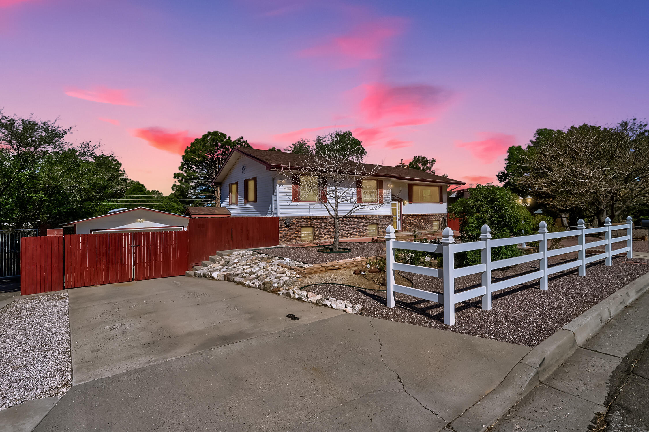 Exceptional NE Heights home with room to live, work, and entertain. This 4-6 bedroom, 2-bath home sits on a generous 1/3-acre lot & features nearly 3,000 sq ft of flexible living space. You'll love the two beautifully updated bathrooms including one with a soaking tub. Flexible Dual living areas provides versatile space for whatever your family's needs. Showcase views of the Sandia Mountains & city lights. Amazing back yard with trees, grass, patios, walkways, garden area and a large deck overlooking it all. The rare 4-car garage provides ample space for vehicles, projects, or storage. Whether you need extra bedrooms, office space, or room for hobbies, this adaptable home delivers comfort and style in one of Albuquerque's most sought-after areas.  Come see this amazing property today!