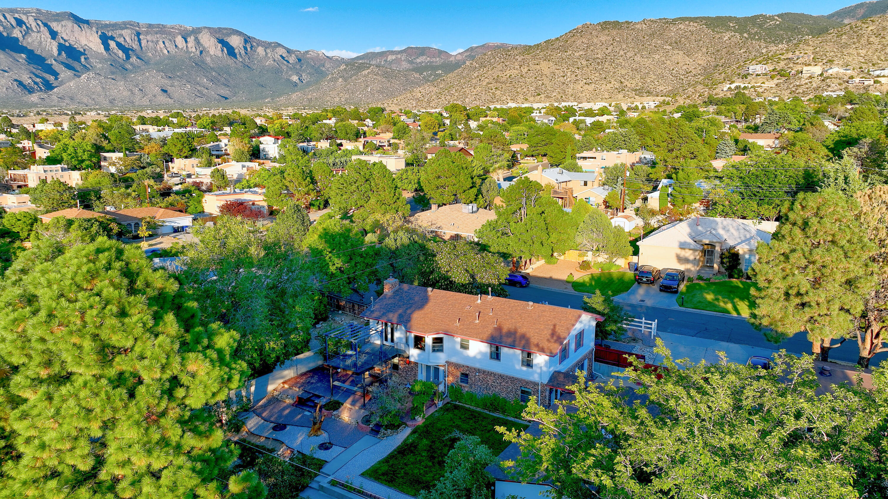 SELLER IS OFFERING A $10,000 CREDIT TO BUYER FOR CLOSING COSTS, INTEREST RATE BUY-DOWN TO MAKE THIS BEAUTIFUL HOME YOUR OWN.Exceptional NE Heights home with room to live, work, and entertain. This 4-6 bedroom, 2-bath home sits on a generous 1/3-acre lot & features nearly 3,000 sq ft of flexible living space. You'll love the two beautifully updated bathrooms including one with a soaking tub. Flexible Dual living areas provides versatile space for whatever your family's needs. Showcase views of the Sandia Mountains & city lights. Amazing back yard with trees, grass, patios, walkways, garden area and a large deck overlooking it all. The rare 4-car garage provides ample space for vehicles, projects, or storage. Whether you need extra bedrooms, office