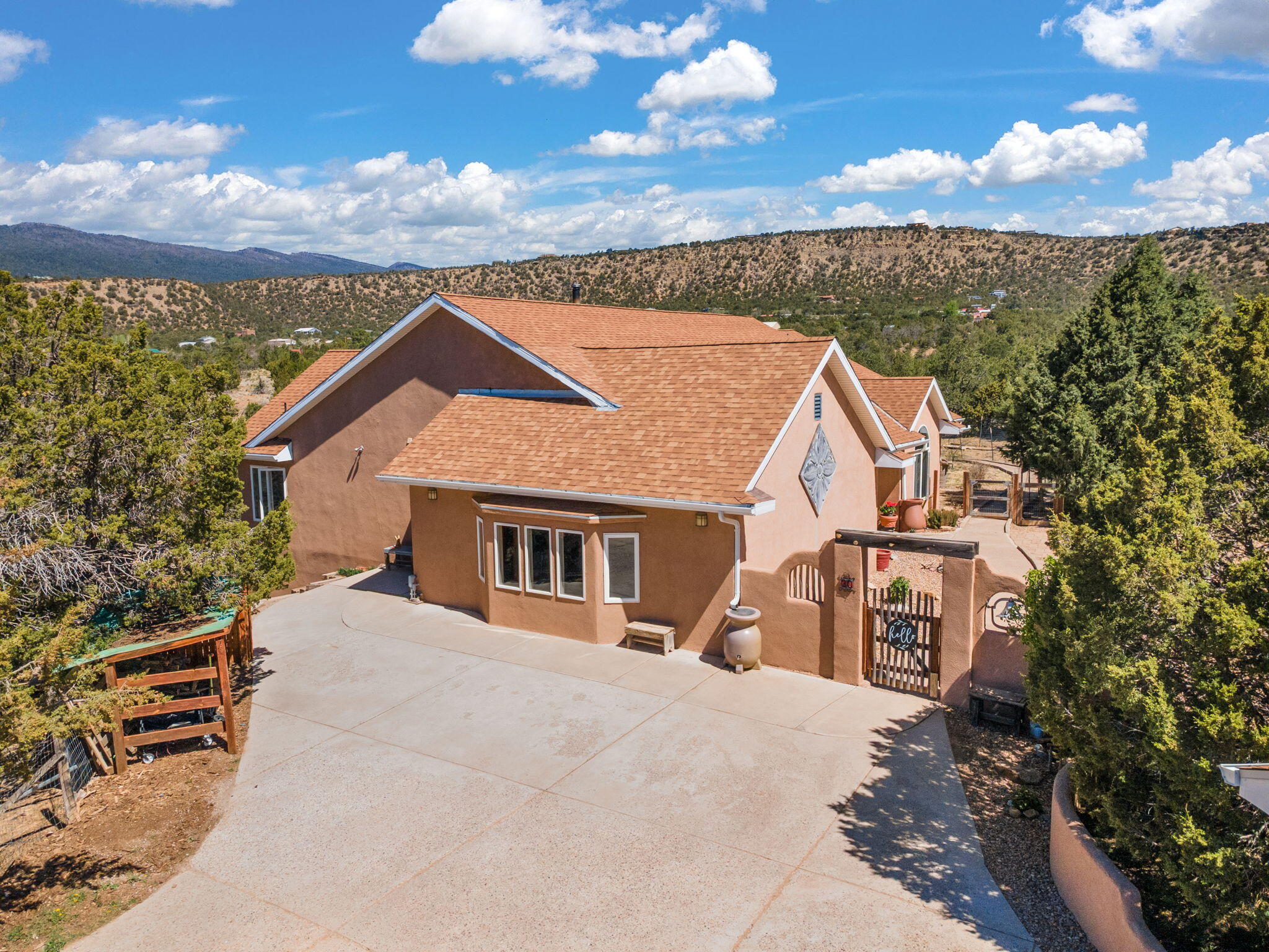 Escape to your own private mountain retreat w/ endless skies & stunning views. Lovingly maintained by original owners, this custom-built home blends timeless Southwestern charm w/ mountain functionality. Features include 5 (possible 6) bds, 528 sqft. REC room, sunroom, vaulted ceilings, & an open floor plan. Enjoy stunning sunsets & incredible stargazing from the deck. The walkout basement includes 2 bds, living area, full bath, kitchenette, & separate laundry - ideal for guests or multigenerational living.  Owned solar, detached 2-car garage, chicken coop, pear tree, ample storage, plus it's on a community well! Wired for backup generator. Just 5 minutes to I-40, making for an easy commute to ABQ. Recent updates include: re-roof (~3 yrs), water heater (~3 yrs), water softener (1 yr).