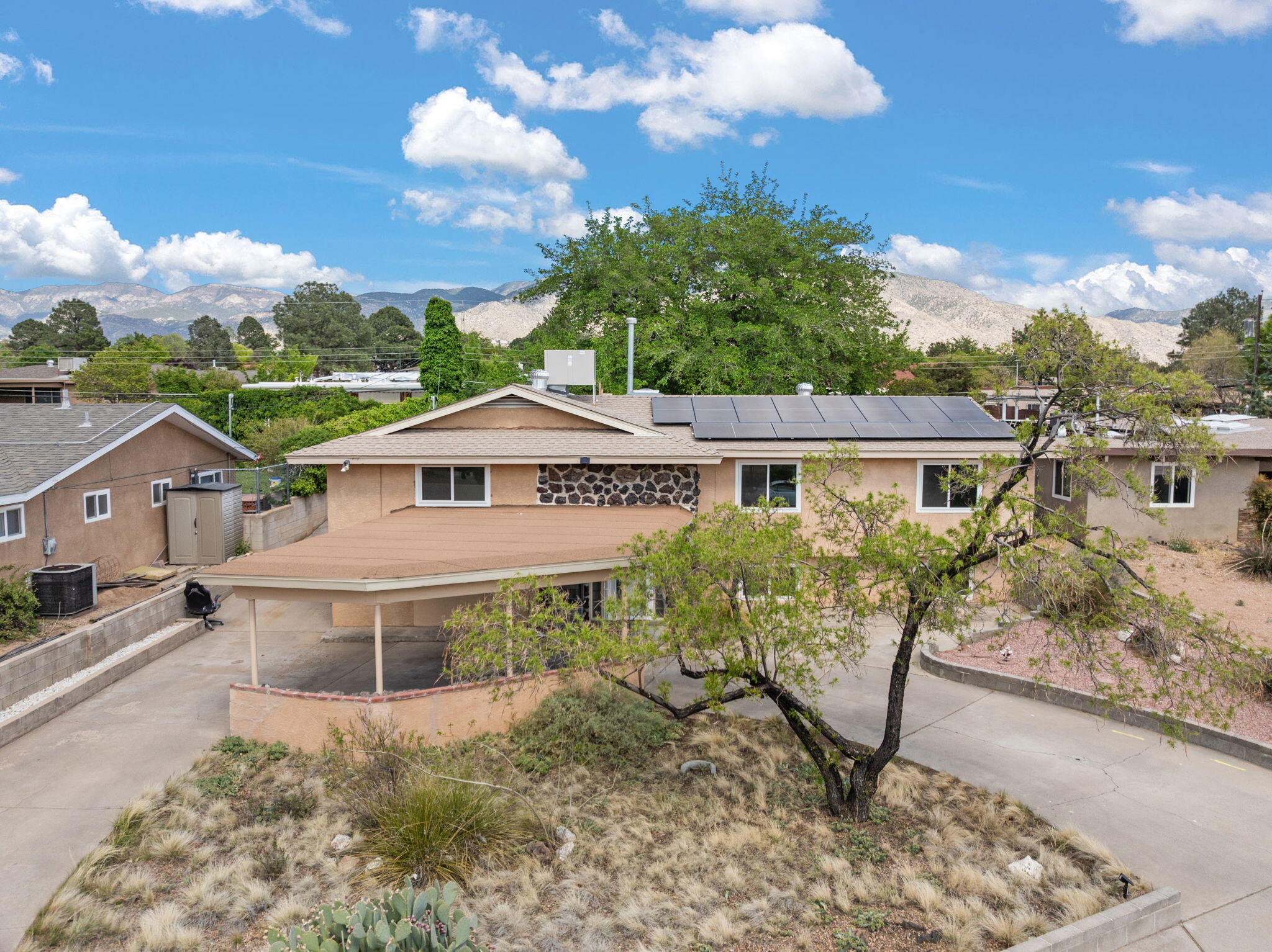 Located in a quiet cul-de-sac in NE Heights, this home offers 4 bedrooms, 2 living areas, and a spacious rec room perfect for a workshop, playroom, or large office. The fully remodeled kitchen features beautiful quartz countertops, and the durable laminate flooring is both kid- and pet-friendly. Enjoy energy savings with solar panels at $179.93/month and new windows installed in 2022. The home also includes RV parking with backyard access. Don't miss this versatile and move-in-ready gem in a prime Albuquerque location!