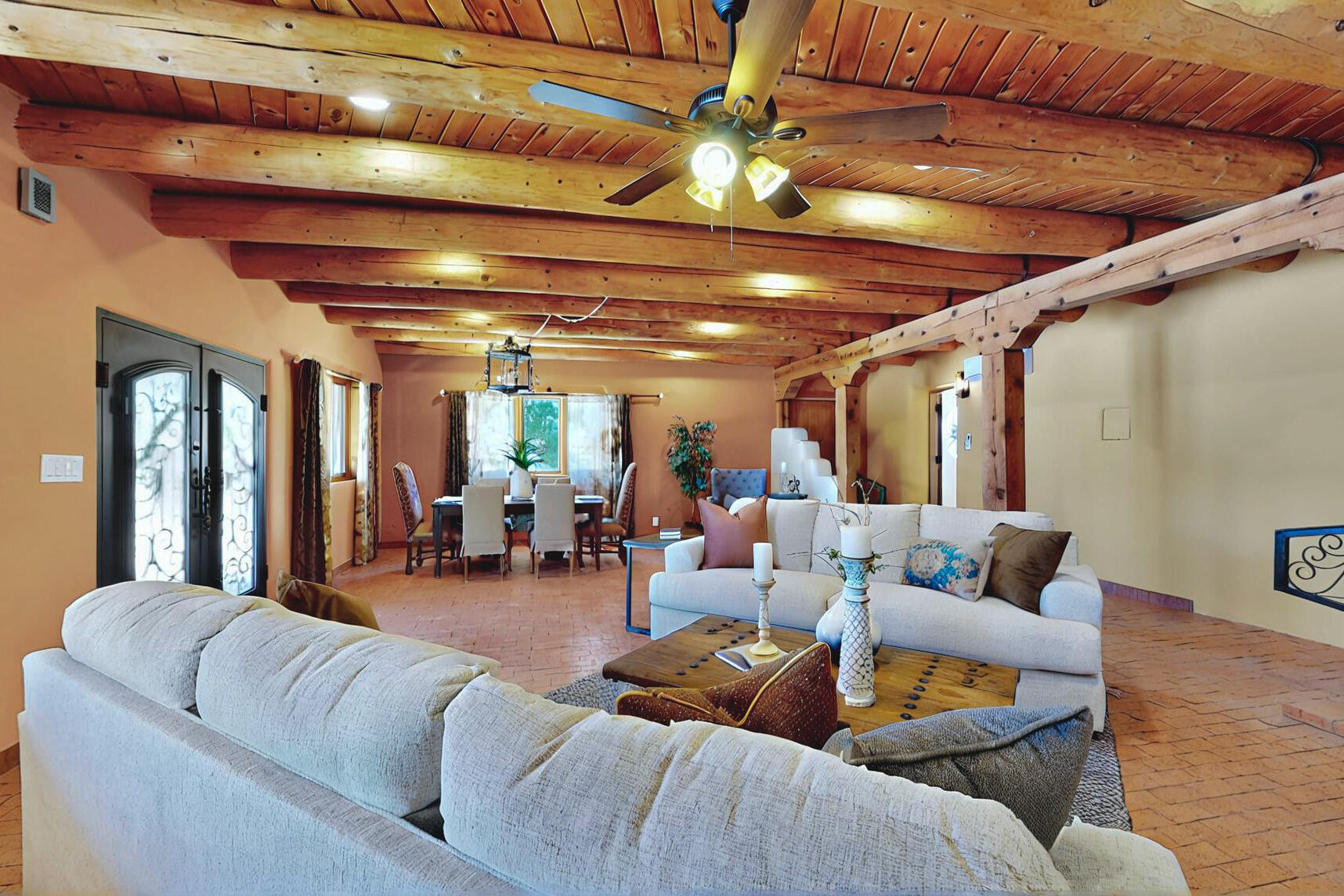 North Valley Hacienda on almost a half acre lot.  Elegant adobe with traditional brick and Saltillo flooring, high gloss plaster kiva fireplace and wood beam ceilings.  Commercial grade kitchen with custom, glazed cabinets and granite countertops.  Clawfoot tub in primary with separate shower.  Two car garage and coyote fencing for privacy.  Private automatic gate.