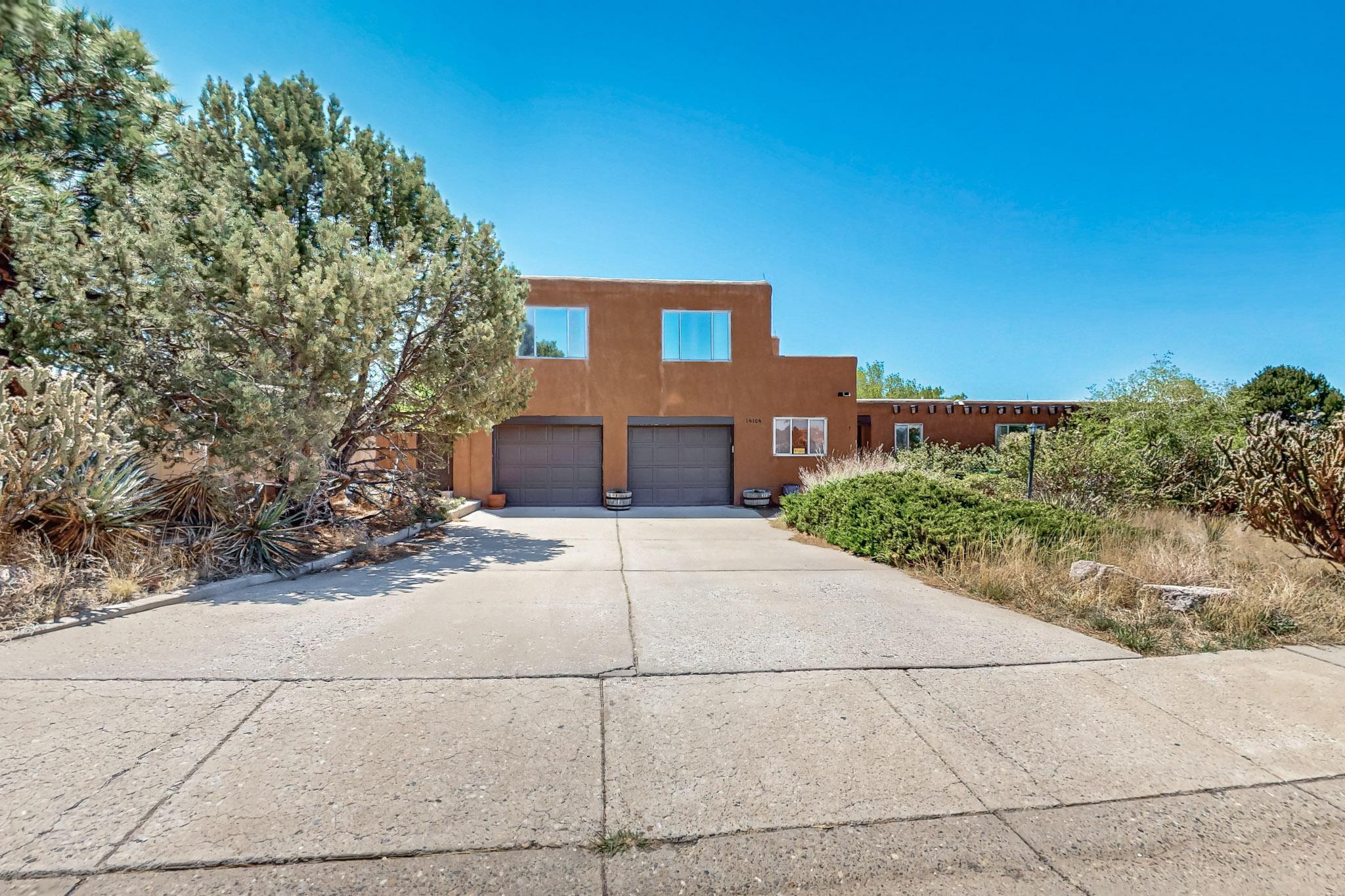 This spectacular custom home, located in the Foothills right across the street from Supper Rock park, is an absolute must see! Enjoy beautiful wood beams and tongue and groove ceilings throughout, two kiva fireplaces, incredible brick floors, extremely efficient insulation that provides cost savings in both winter and summer, plus fantastic views of Supper Rock and the Foothills from the balcony; and that's just the inside. Outside on the 1/3 acre corner lot, you get a second driveway and gate with backyard access. a lush corner grove with huge mature trees, an expanded garden area, and colorful and aromatic rose bushes!  Also, a new TPO roof, new water heater, and the drip irrigation has been recently upgraded!   Don't miss it, schedule your private tour today!