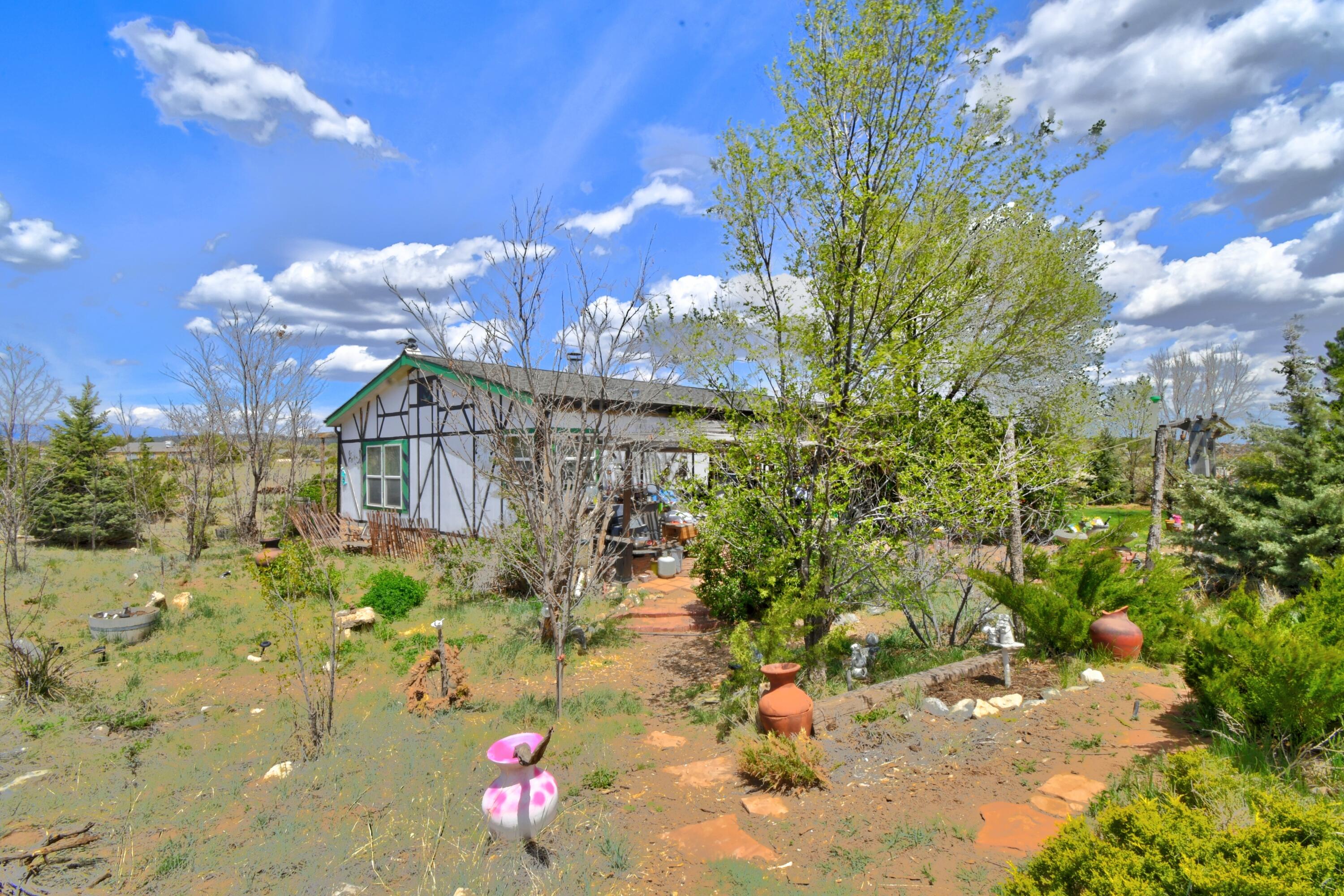 Discover the charm of country living just 30 minutes from Albuquerque in this beautifully situated property in Edgewood, New Mexico. Nestled on 11 acres of gently rolling terrain with expansive privacy, space, and incredible potential. The property includes a 2 bedroom, 2 bath home with an open floor plan, abundant natural light, paid off solar panels and a cozy wood-burning stove--perfect for cool evenings. Whether you're looking for a hobby farm, horse property, or just room to roam, the land is ready for your vision. Enjoy clear skies, fresh air, and peaceful surroundings while still being close to local schools, shopping, and dining. This Edgewood gem offers the best of rural New Mexico living--don't miss this opportunity to make it your own.