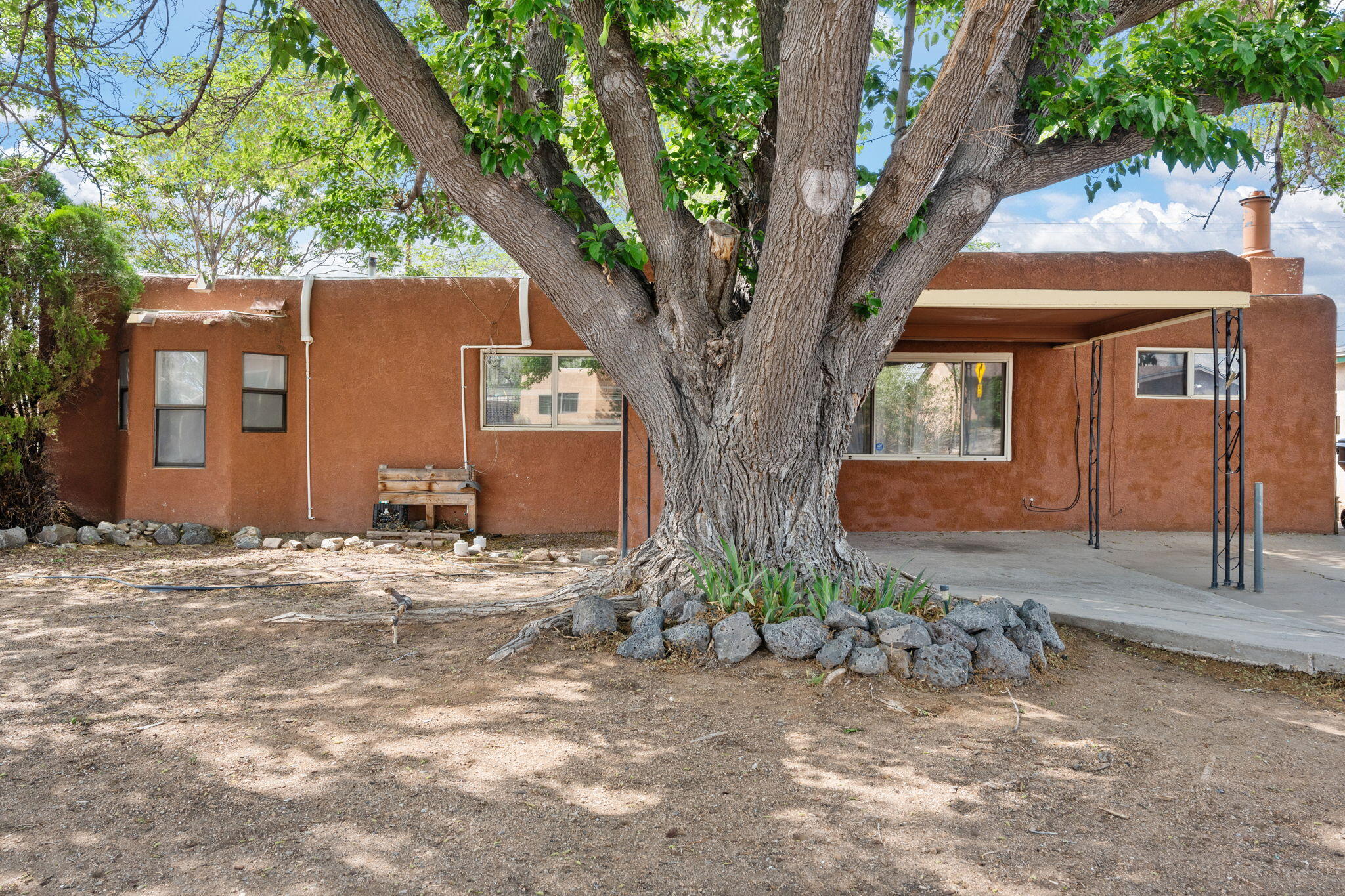 Great NE heights location! This cute home sites under beautiful shade trees, with a HUGE backyard.  New roof about 2 yrs ago, new mini-spits last year for heating and cooling! Walk to a number of great local restaurants and ABQ Coffee in The Albuquerque Collective! This is a great little starter home with a large living space with wood burning fireplace. Patio and large yards/trees make for great outdoor living and tons of potential!  See it now, before it gets away!