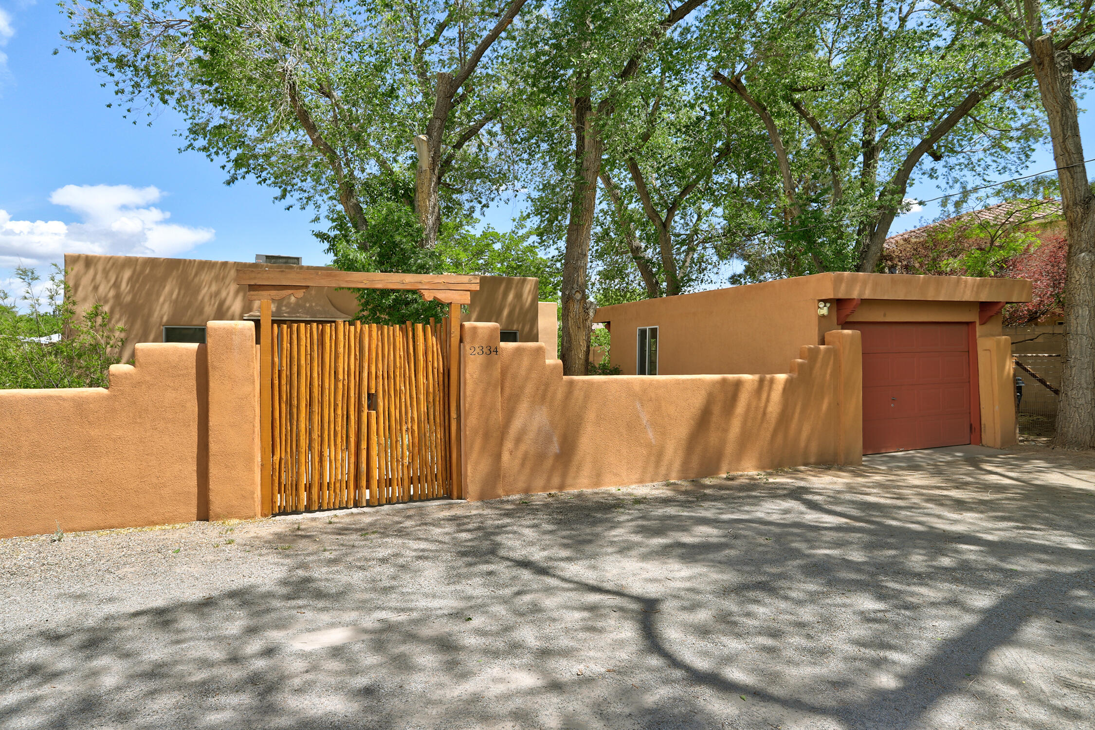 Come home down one of the city's most beloved boulevards to this near North Valley gem! Do you feel called to a simpler lifestyle grounded in nature with proximity to walking and biking trails and healthy living in a supportive co-housing community?  Join Acequia Jardin! A perfect blend of historic charm and modern convenience, this 2 BR 1 BA built in 1936 was conscientiously upgraded in 2014. Enclosed by a serene private courtyard, the home is nestled in the planned  community yet retains its own space. and one car garage.  You'll love the warmth of oak floors bathed in abundant natural light from wood windows.Amenities include refrigerated air, tankless water heater, gas stove, updated kitchen and bath.The outdoor is a garden oasis that captures the charm of rural living yet