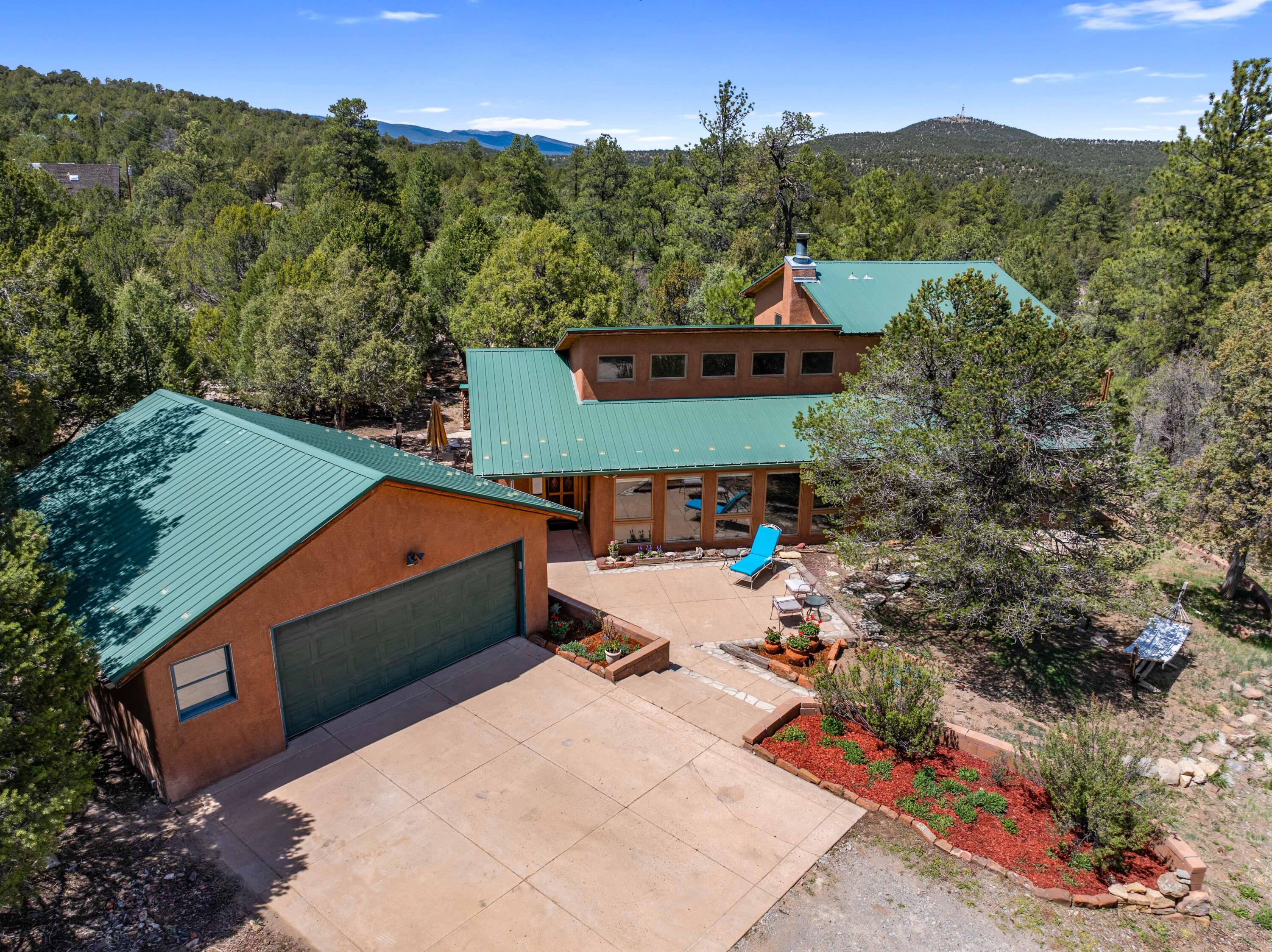 Get ready for fun in this incredible home, only 15 mins from Albuquerque! With a bright and airy open floor plan, every corner of this abode is infused with joy, featuring sparkling Italian porcelain floors and exquisite custom lighting! You'll love the craftsmanship of the stunning front door, expertly built by Master Craftsman Peter Barlow. Enjoy the spaciousness of large bedrooms, walk-in closets and the oversized garage with workshop area & storage. The home caters to your comfort with Pella windows, an advanced boiler system providing radiant floor heating and a well-maintained yard that welcomes birds and nature! Don't forget the barn and chicken coop, perfect for your outdoor adventures and hobbies! 5G Internet available with 100mbps or more!