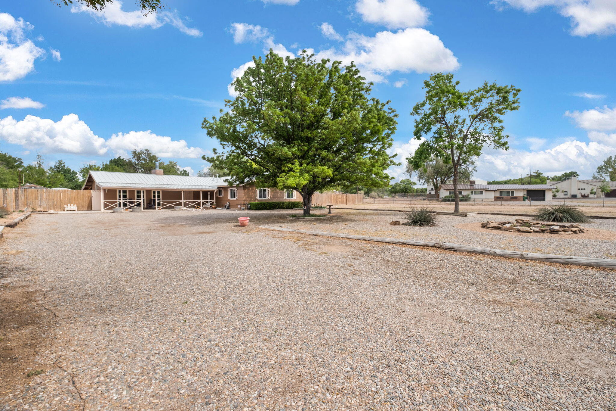 Gorgeous South Valley Farms home on 1 acre of A-1 zoned land! Enjoy multiple trees, lush grass, and a beautiful backyard with a covered patio, pergola, and storage sheds. Inside features Saltillo tile throughout, two living spaces, and an updated kitchen. The home has a durable metal roof and refrigerated air. A rare find with space and charm that feels like country living!