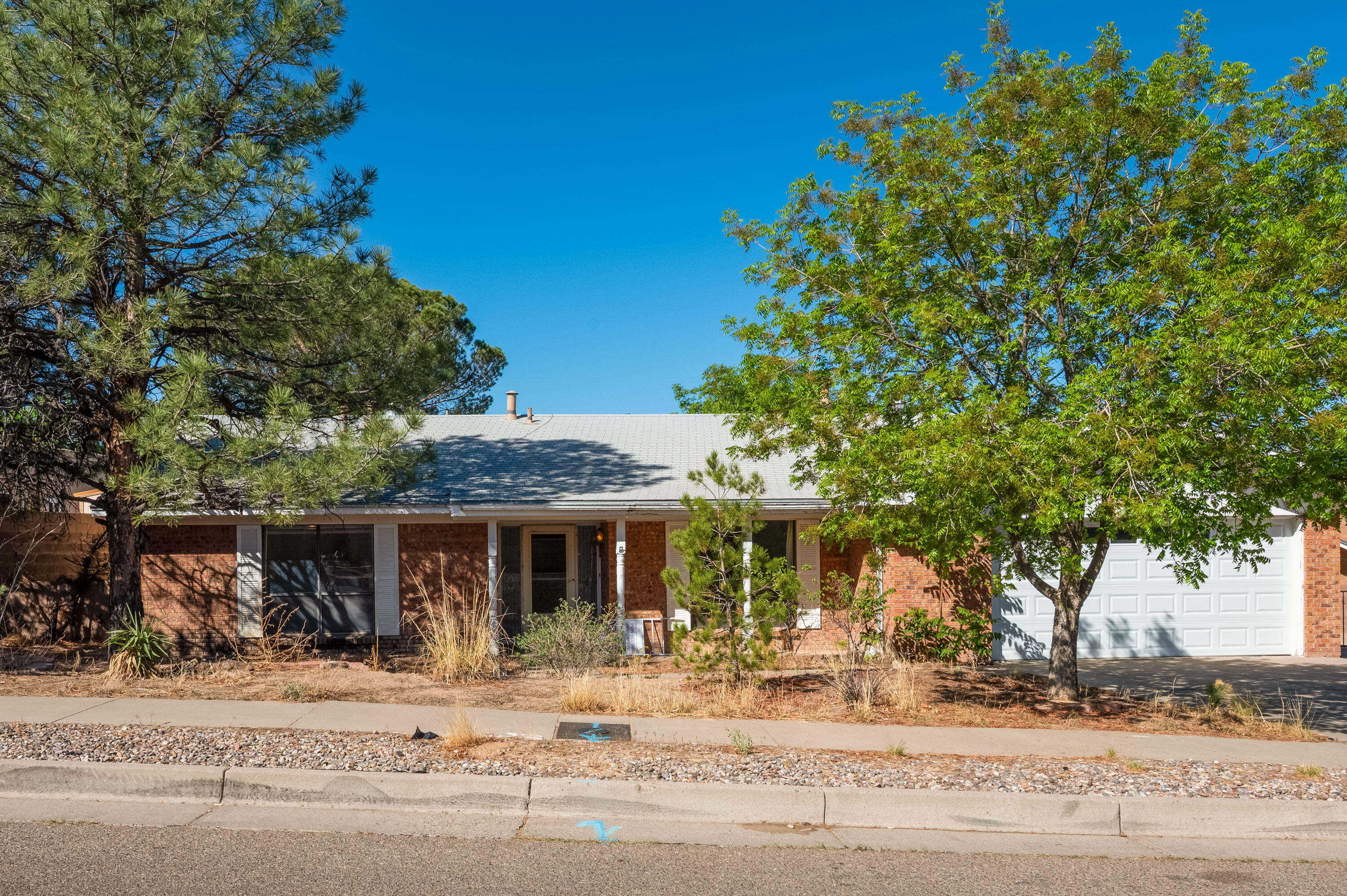 In one of the most sought after areas, south of Tanoan guard gate, on a large lot with backyard access possible and RV parking available. Needing some paint and imagination and this gem could be yours because this home has not had updates done.  Storage in backyard.   Potential abounds in this home .  Primary bedroom is on north side of the floorplan and the other two bedrooms are on the southern side.  Come check out what could be your forever home!