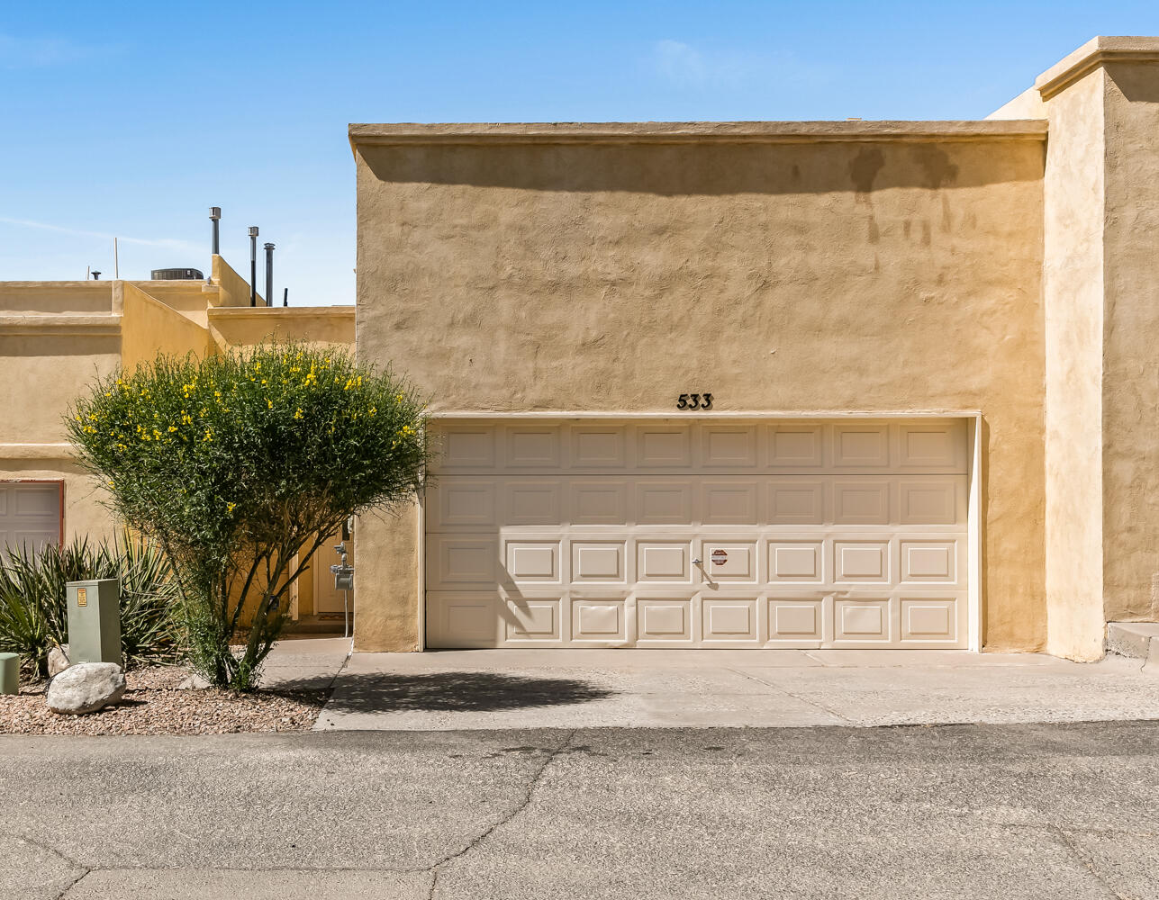 Fabulous townhome in Four Hills with sweeping views!!!  This light filled property backs to open, natural southwest landscape and boasts many features including: Huge living room with soaring ceilings, clear story windows, skylights, designer light fixtures & French doors to the balcony,  Kitchen with stainless appliances, bar for plenty of seating & a breakfast nook,  Large primary suite with walk-in closet &  balcony access,  2 secondary bedrooms with the flexibility of one being an additional primary suite, 3 bathrooms, 2 car garage with storage & fenced backyard with a gate to the nature beyond complete this beauty!  Conveniently located in the foothills near hiking & biking trails, I-40 & shopping.  Don't miss this one!