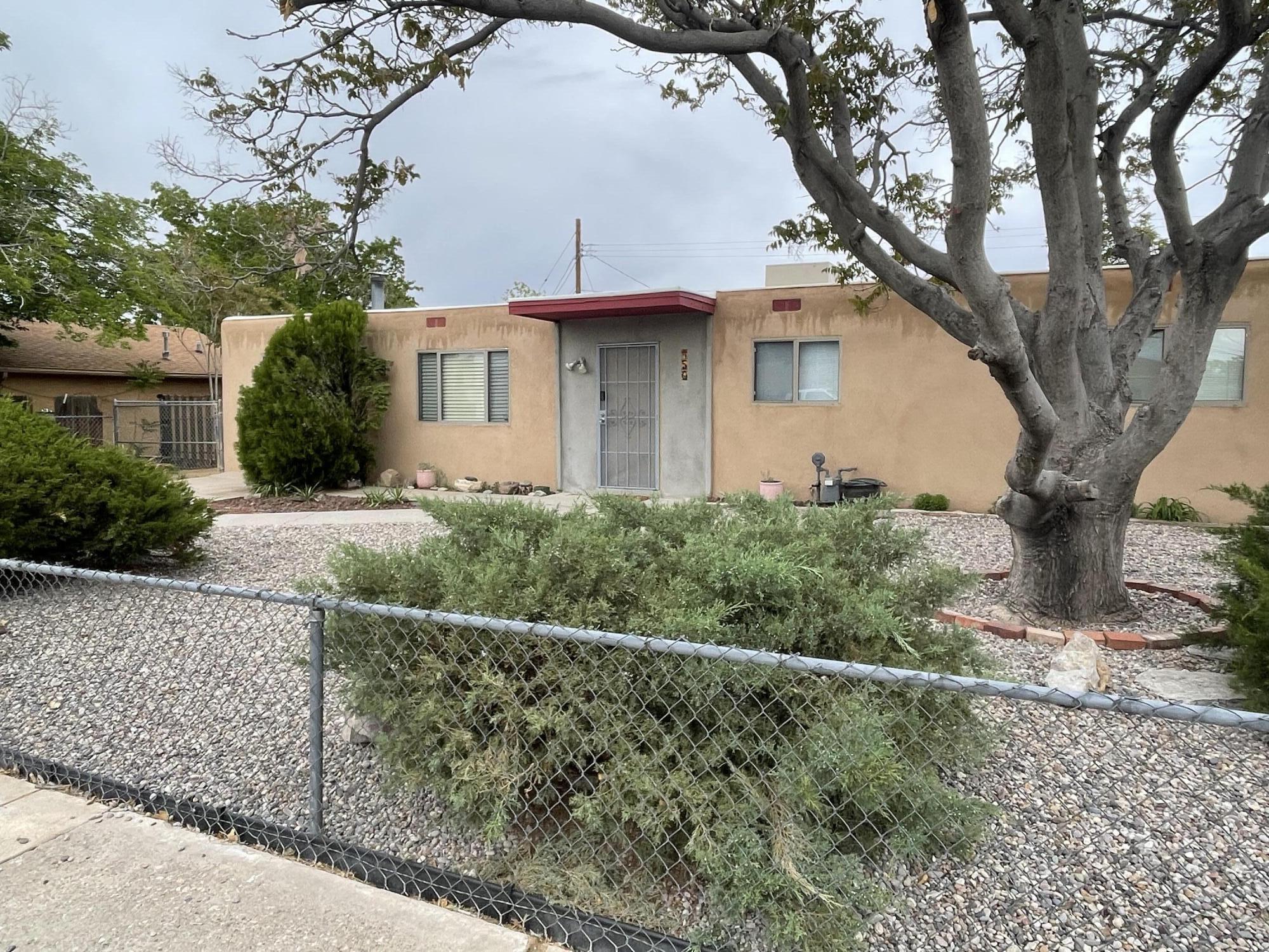 This beautifully maintained home is centrally located near a variety of amenities. Recent updates include new stucco in 2025 and a TPO roof installed in 2022. The front yard is xeriscaped with mature trees, while other upgrades feature a newer water heater, fresh interior paint, and updated double-pane windows.Inside, you'll find three generously sized bedrooms with newer carpet and fresh paint throughout. The home also offers a spacious kitchen and a cozy den, perfect for relaxing or entertaining.Conveniently situated just minutes from grocery stores, entertainment, and the historic Route 66, this property combines comfort and location. The backyard is a blank canvas, ready for your personal touch and creative vision.