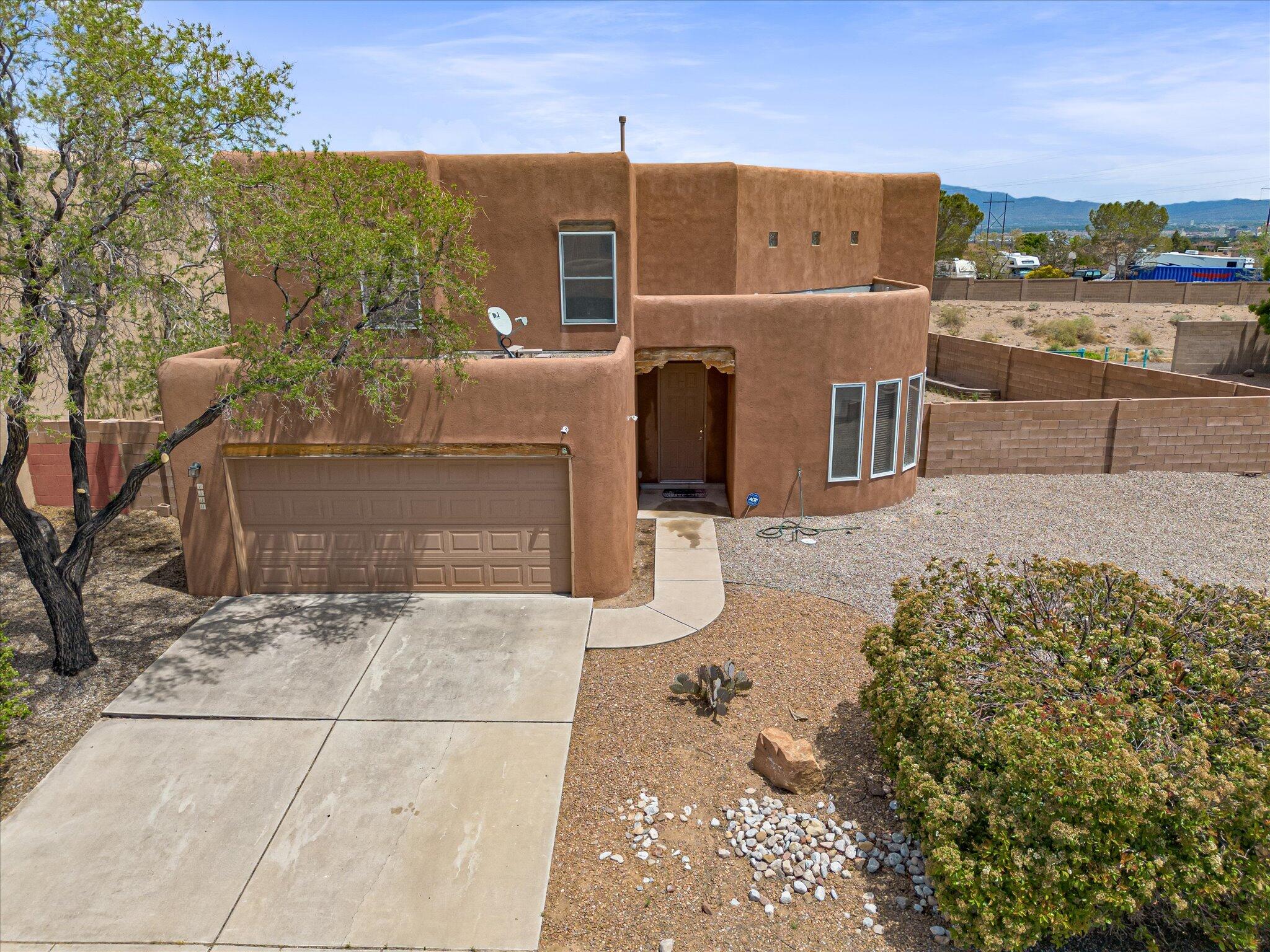 Stunning home on a premium private lot with unobstructed mountain and city views--no neighbors to the south or east! Recently updated with new carpet, fresh paint, and new toilets (2025). Bright and open layout with vaulted ceilings, spacious living areas, and a kitchen with breakfast bar and ample storage. Versatile flex room on the main level with closet--ideal for office or 4th bedroom. Primary suite features garden tub, double vanity, shower & walk-in closet. Enjoy sunrise views from your private deck. Oversized patio, garden space, auto sprinklers, and backyard access. Quiet neighborhood near new retail at Unser & Ladera. Move-in ready with space, style, and views