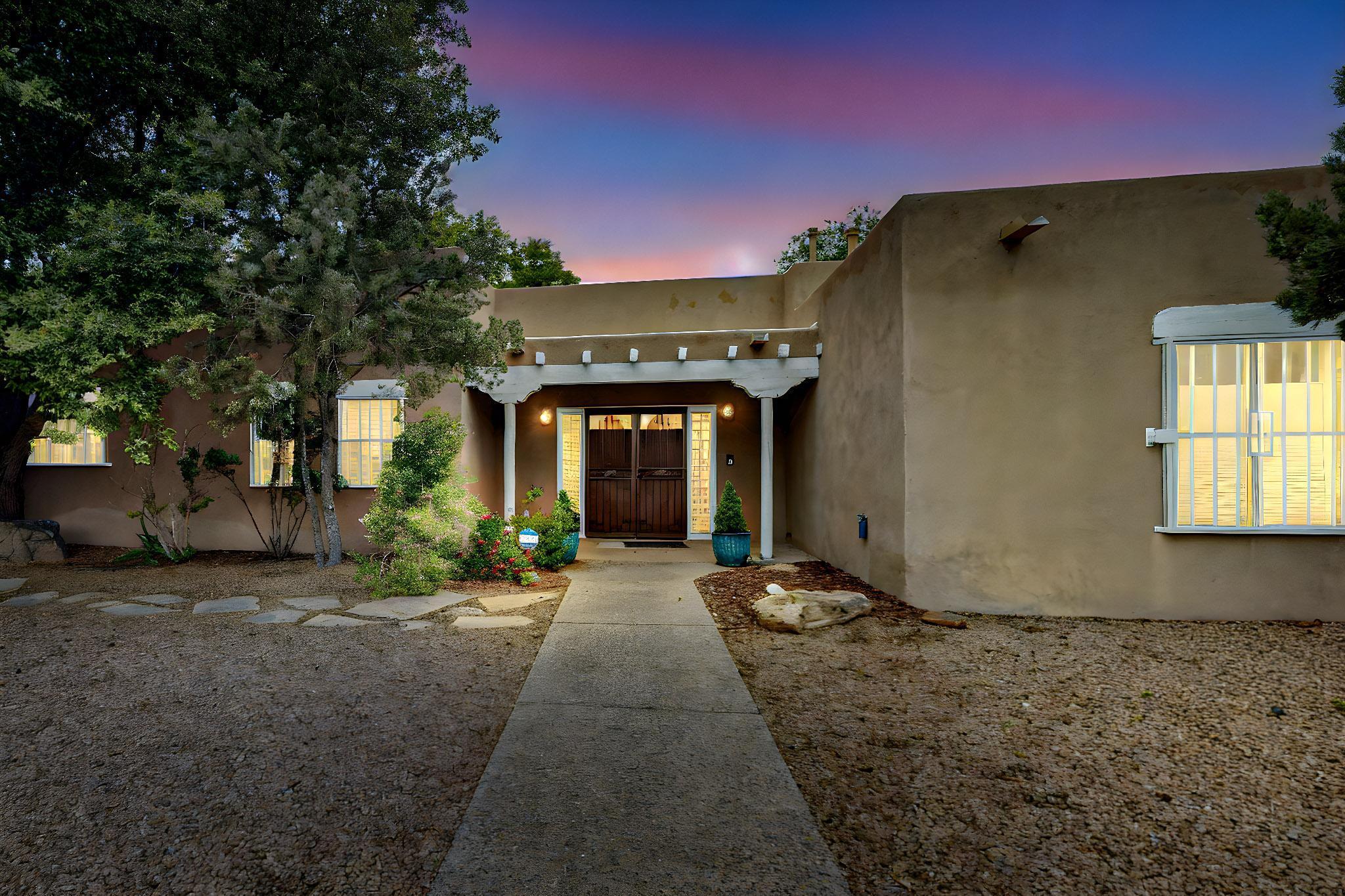 Absolutely stunning Matthew Meadows gem in the heart of the North Valley! This 4 bedroom 3 bathroom home blends modern construction and upgrades with classic Southwestern charm. Enter through elegant double doors into a grand living space featuring tongue-and-groove beamed ceilings, a large Kiva fireplace, and timeless brick floors. The 3-year-old remodeled kitchen shines with white shaker cabinets, Corian countertops (complete with waterfall peninsula) and 3-year-old Bosch appliances. Enjoy two spacious living areas, a dining room, and a luxurious primary suite with a kiva fireplace, spa inspired bath and French doors opening to a lush backyard.  This home truly is Move-In-Ready with 3-year-old central refrigerated air and heat, along with a 3-year-old TPO roof.  Welcome Home!