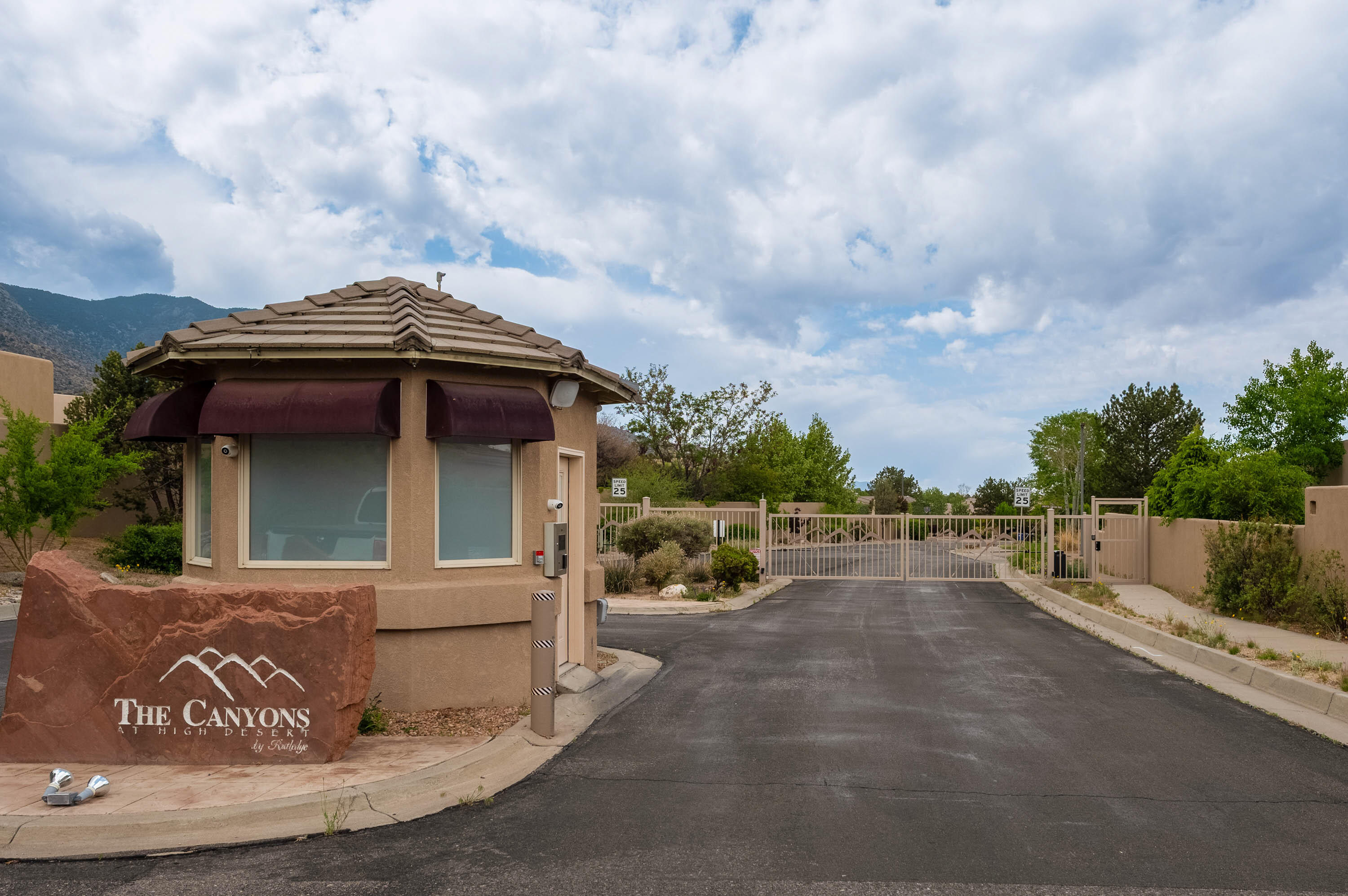Stunning former Rutledge Model Home located in the gated ''Canyons'' at High Desert. Prime lot & location backing to open space, offering breathtaking city/mountain views. Striking carved posts & corbels frame the expansive living & dining areas, w/hardwood floors, kiva f/p w/gas logs plus a wall of windows that bring the outdoors in. Redesigned kitchen w/lg granite island & countertops/backsplash, stainless appliances, Wolfe gas cooktop, Sub-Zero refrigerator, wine fridge, automated blinds on all windows & sliding doors. Private owner's suite with a cozy kiva f/p & sitting area. Bath w/garden tub, frameless glass shower, dual sinks, walk-in closet. Add'l lg Bedrms, full & 1/2 bath, Utility room, TPO roof, AC/Heating units 11/22,  updated interior paint, finished 3 car garage & so more!