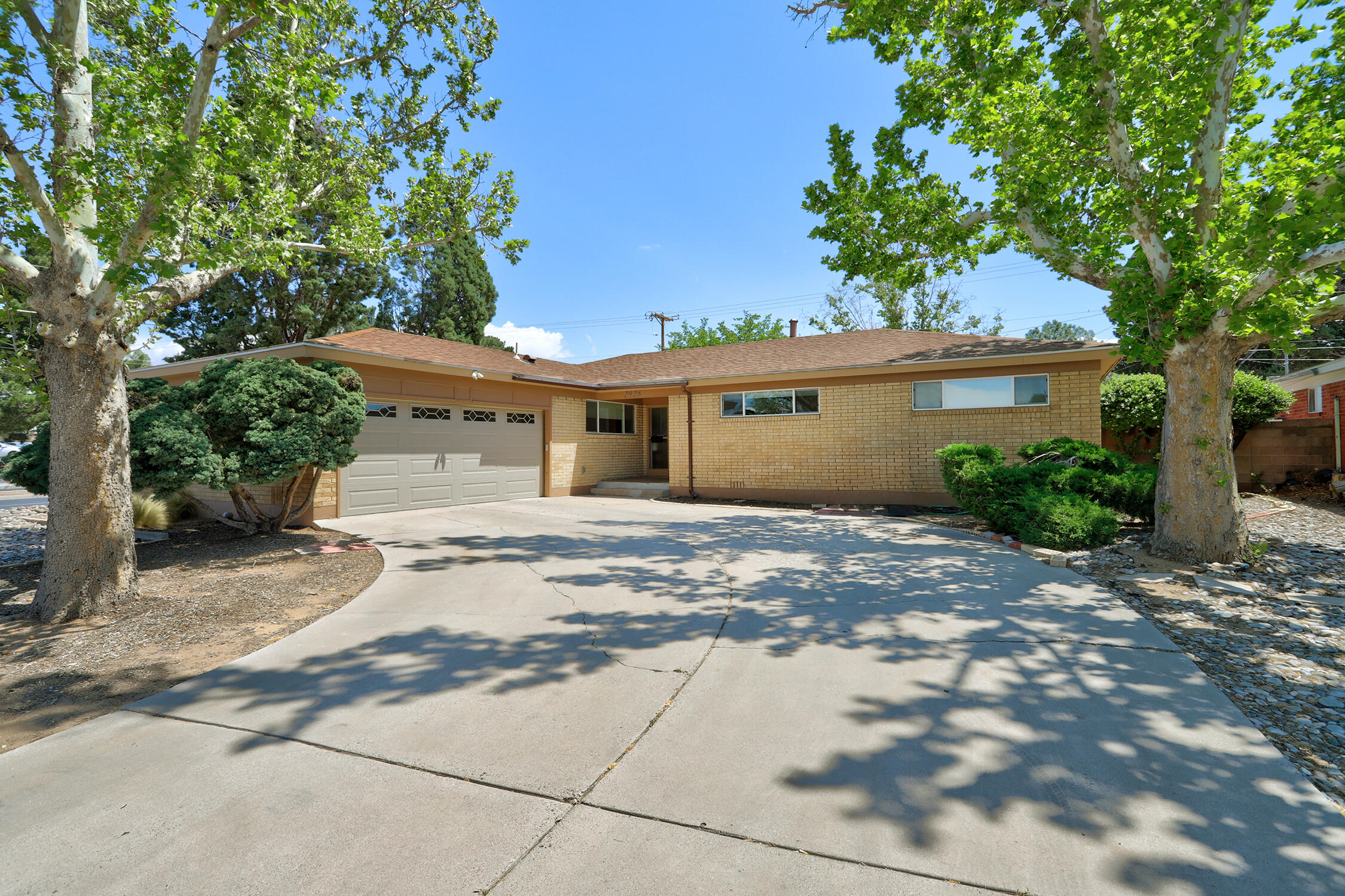 Welcome home to this beautifully updated single-story property featuring a great floor plan with 4 spacious bedrooms and 2.5 bathrooms--completely move-in ready! Step into a bright, open layout filled with natural light, and enjoy cooking in the well-equipped kitchen, complete with sleek stainless steel appliances and ample storage. Tile and laminate floor throughout-no carpet! The primary bathroom boasts a double-sink vanity, while one of the secondary bathrooms includes a roll-in shower for added accessibility. Outside, enjoy the lush green lawn and a large covered patio--perfect for relaxing or entertaining. A convenient ramp adds extra ease and functionality to the outdoor space. Great location near from Sandia High School, shopping, parks and more. Come call this home today!
