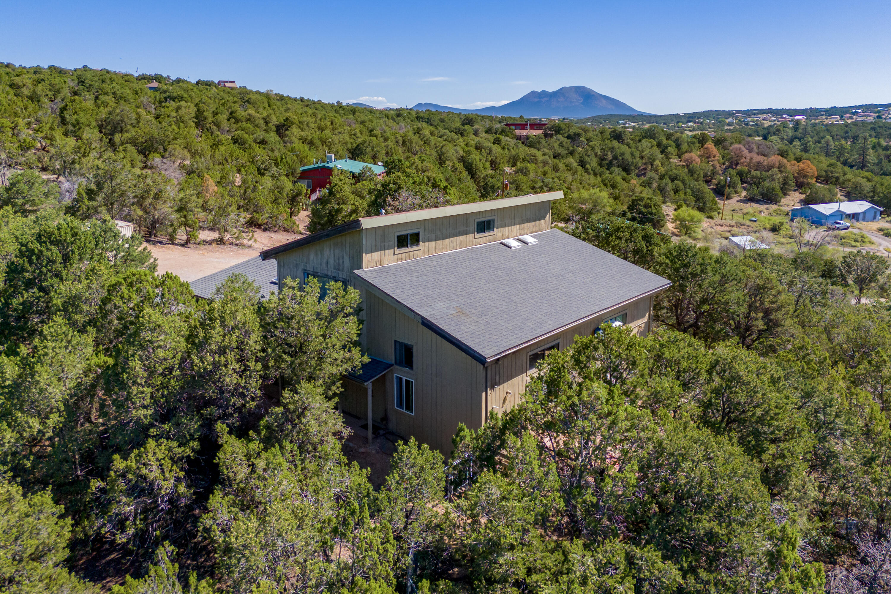 This exquisite, remodeled home boasting 3 bedrooms, 3 bathrooms, and a generous 2500 square feet of living space. Soaring high ceilings that create an open and airy atmosphere. The custom metal staircase serves as a stunning centerpiece, inviting you up to the well-appointed rooms. Bask in breathtaking views from your property, further enhanced by the privacy of a gated driveway. Enjoy the convenience of ceiling fans and updated light fixtures ensuring comfort and style go hand-in-hand. Stay cozy with the latest technology at your fingertips, such as a pellet stove (2022) with wireless thermometer control, and propane wall units (July 2024). Take advantage of the huge bonus room with a full bath, perfect for game room area, or whatever your heart desires.
