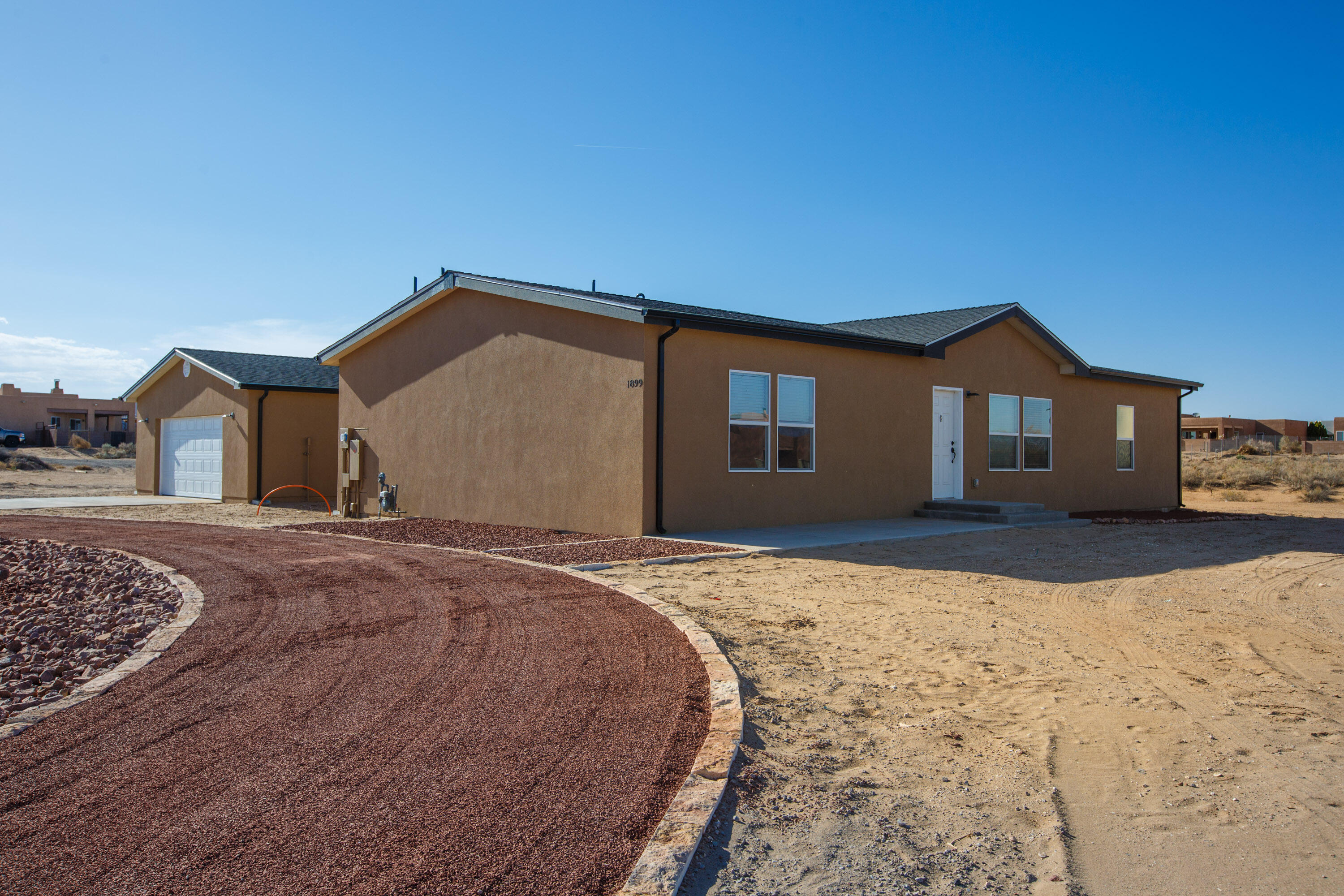 ****Seller Special - $10,000 credit for interest rate buy down, landscaping or other buyer concessions (expires July 31). Wake up to forever mountain views on 1.2 wide-open acres! This 1,800 SF, 3-bedroom, 2-bath home blends quality, comfort, and possibility--featuring 2x6 and 2x4 construction, refrigerated air, stainless steel appliances, and a separate 2-car garage. Inside, enjoy a luxury bath with garden tub, double sinks, and walk-in shower, plus walk-in closets in every bedroom. The spacious eat-in kitchen/dining area boasts a massive island and an extra-large walk-in pantry. With room to build ADUs, a workshop, or your own urban homestead, this gem near the Unser corridor and Rust Hospital has it all.  **Interior photos are from the model home prior to completion.  Finishes vary.