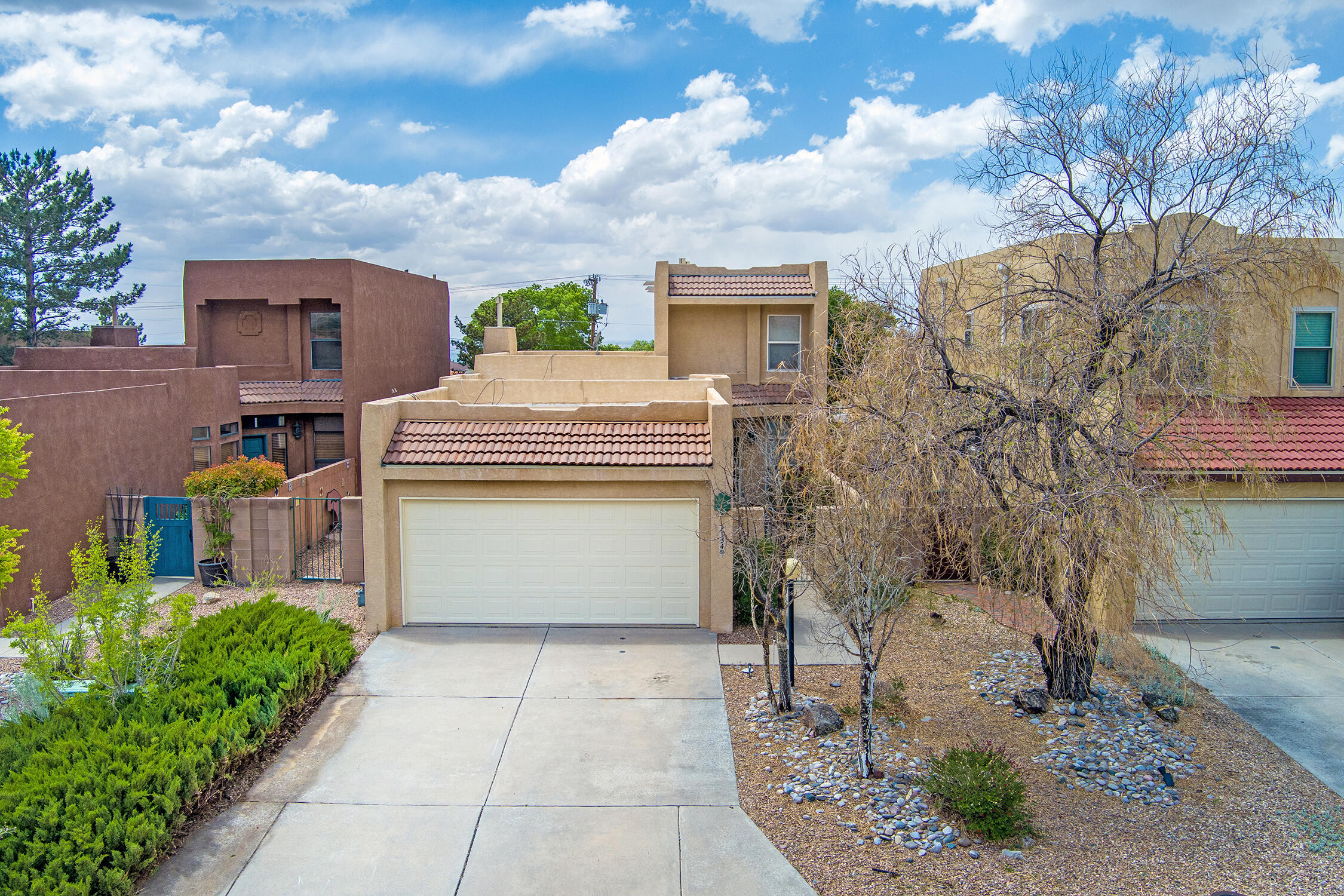 This bright & inviting home features a thoughtful layout with plenty of natural light throughout, and the tall ceilings are sure to impress. The kitchen includes granite countertops, a tile backsplash, a convenient island, a gas stove, and stainless steel appliances--perfect for both everyday living and entertaining. Enjoy stunning views to the east and west, taking in the beauty of both sunrise & sunset. The primary bedroom is located on the main floor, with two additional bedrooms upstairs for added flexibility. A new TPO roof was installed in 2024 & comes with a transferable warranty for peace of mind. The backyard features a tiled patio--perfect for relaxing and enjoying the beautiful NM sunsets. Located in a highly desirable area with top-rated schools & a quiet, tucked-away setting