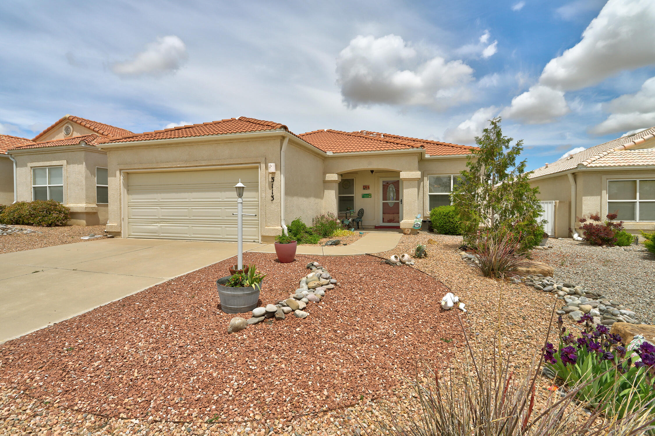 Check out this fantastic 3-bedroom, 2-bath home in the lovely High Resort area!  It has a warm and inviting feel with wood and tile floors, eliminating the hassle of carpet. The kitchen, equipped with stylish quartz counters, sits conveniently at the back of the house, right by the patio, making it ideal for entertaining friends and family. Plus, the syn lawn adds a touch of green without the upkeep! Enjoy the views rop of the Sandia Mountains and the added privacy of no rear neighbors.  Owner has updated the baths with stylish vanities.Don't forget the water softener, adding convenience to your everyday life! Such a sweet casa, located on a quiet, private loop. This home is ready for your personal touches!