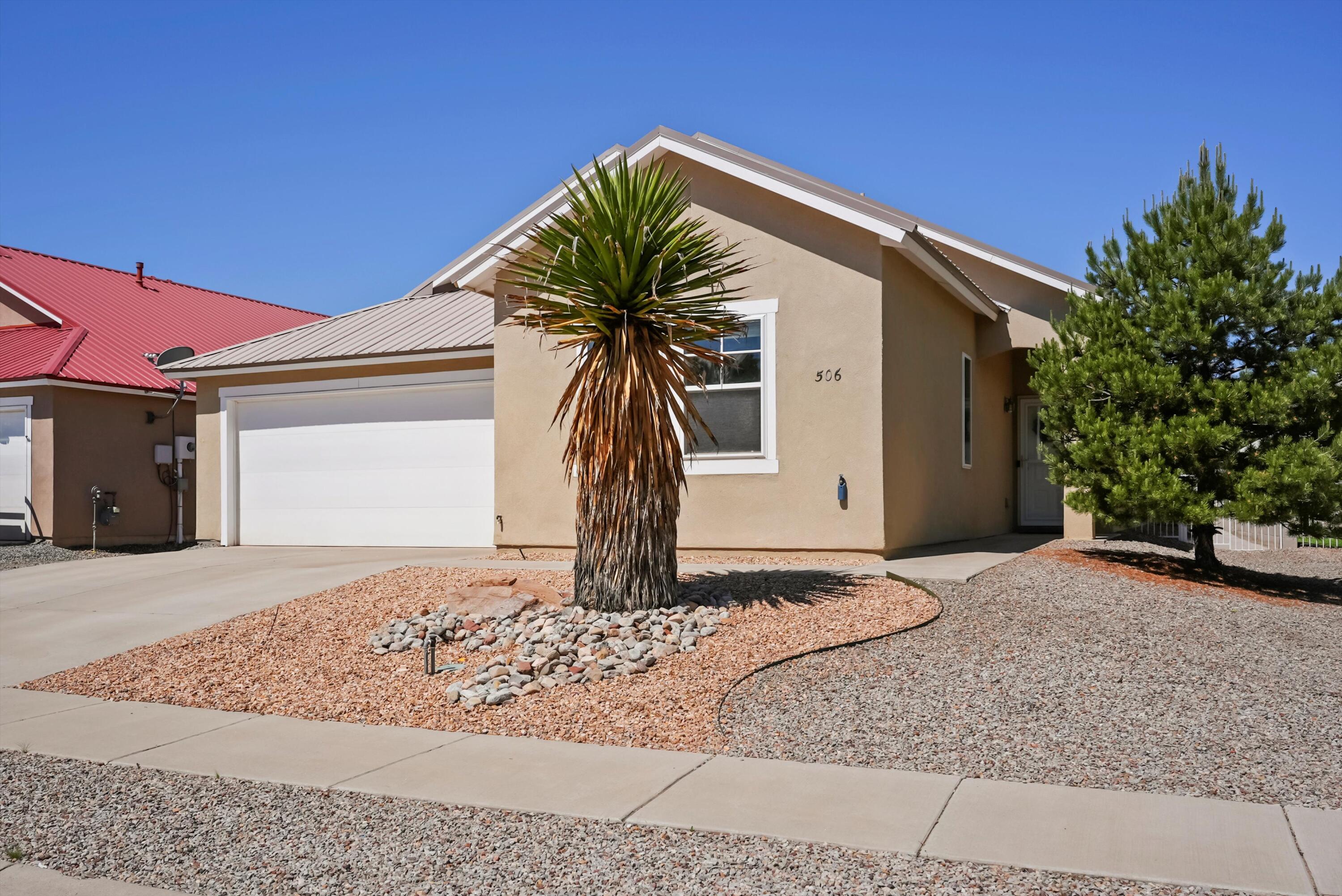 Charming 3-bed, 2-bath Rio Rancho home with tall ceilings and an open layout. The kitchen includes plenty of counter space and ample cabinet space. The spacious primary suite features a garden tub, double vanity, and walk-in closet. Enjoy a low-maintenance backyard with xeriscaping and a covered patio. Home also offers refrigerated air, thermal windows, and a durable metal roof. Conveniently located near schools, shopping, and dining. All appliances including Washer & Dryer come with the home!