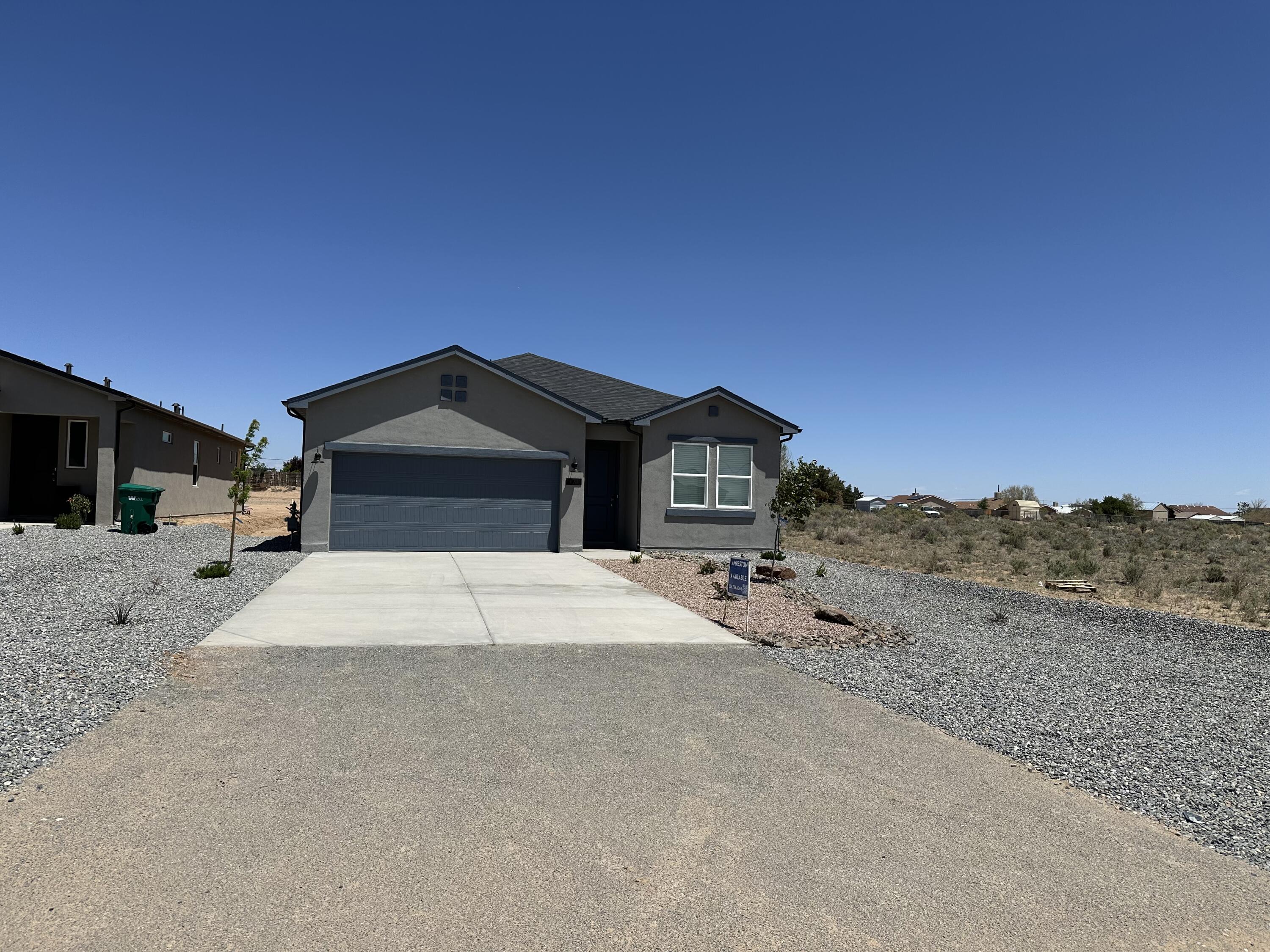 Located on a quarter acre lot, this four bed, three bath home offers 1,994 SQ FT of contemporary living space built to Green Build New Mexico Gold standards, ensuring superior energy efficiency and sustainability. The open floor plan is designed for modern living, featuring a owner's suite sitting area, and a striking twelve-foot sliding glass door connecting indoor and outdoor spaces. Enjoy the large covered patio, perfect for relaxing or entertaining. The kitchen is equipped with high-end stainless steel appliances and a walk in pantry. Don't miss this opportunity to own a home that blends luxury with eco-friendly features! Call today to schedule a tour or inquire about available buyer incentives!
