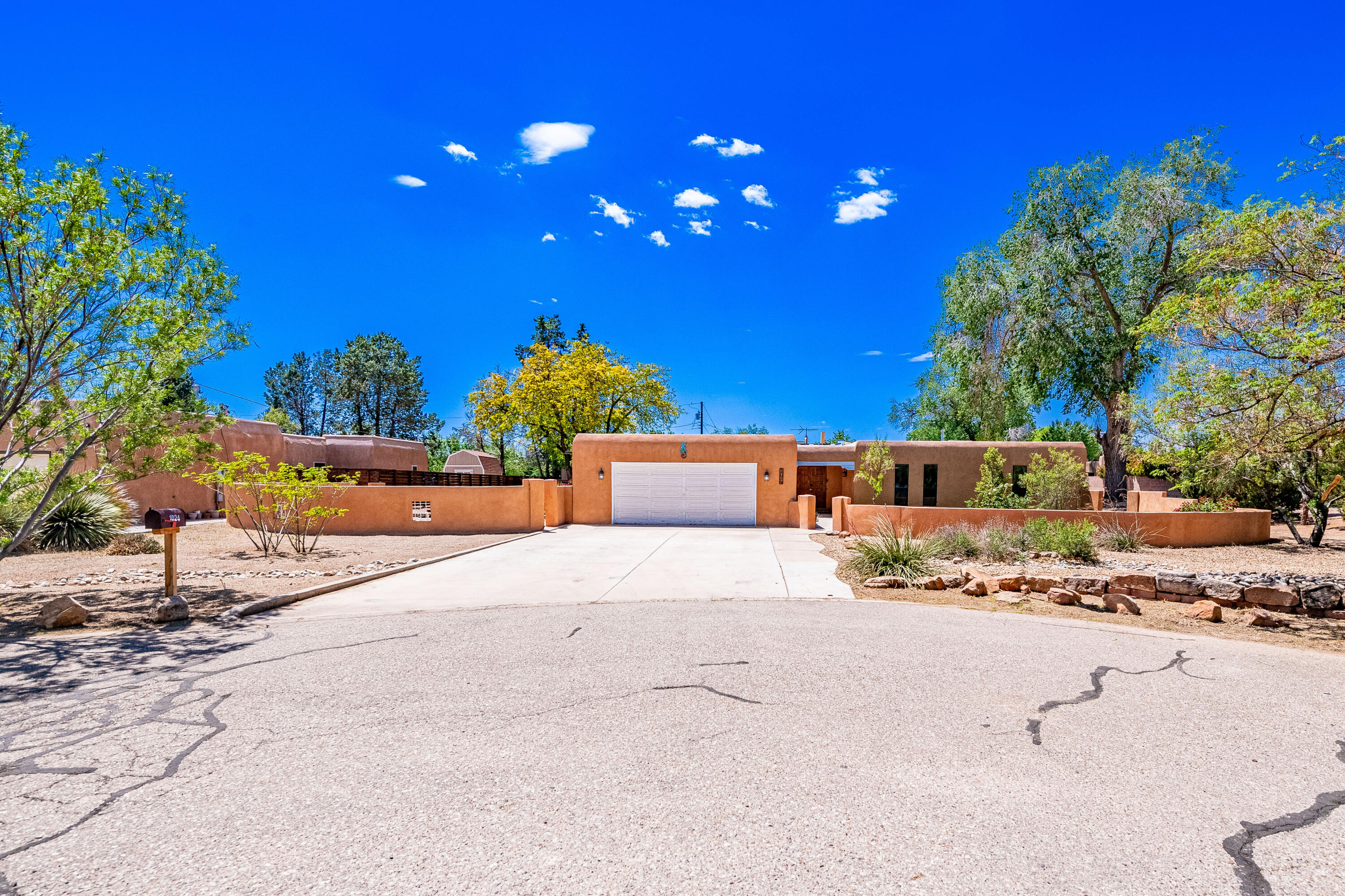 Nestled on an expansive lot in the desirable North Valley and just a short walk to Los Poblanos Open Space, this charming home offers endless possibilities with convenient backyard access. The spacious yard invites you to create your ideal outdoor oasis or utilize the ample space for storage. Inside, the home features striking exposed wood beam ceilings, classic brick flooring, and carpet in the bedrooms. Enjoy energy savings with owned solar panels and easy access to major roads for a quick commute. Ready for its new owners to make it their own - schedule your showing today!