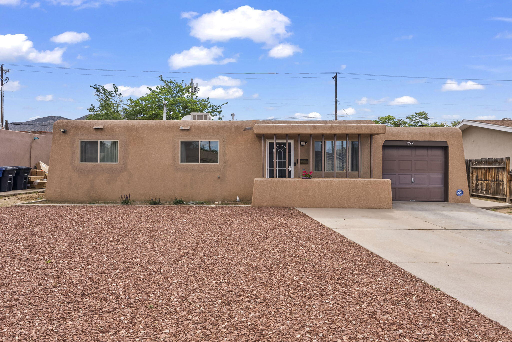 Welcome to this delightful home that blends New Mexico pueblo style charm on the exterior with modern conveniences inside. From the moment you arrive, you'll be greeted by inviting curb appeal, warm natural light, and thoughtfully designed living spaces. The highlight of this home is the beautifully updated kitchen- featuring quartz countertops, contemporary cabinetry, black steel appliances, and stylish fixtures. It's the perfect space for cooking, gathering, and making lasting memories. With cozy living areas, comfortable bedrooms, and a spacious backyard ideal for relaxing or entertaining, this home offers the perfect balance of comfort and style. Updates include mini split (2023), furnace (2023), kitchen renovations (2023), black steel appliances (2023), dishwasher (2025), roof (2024)