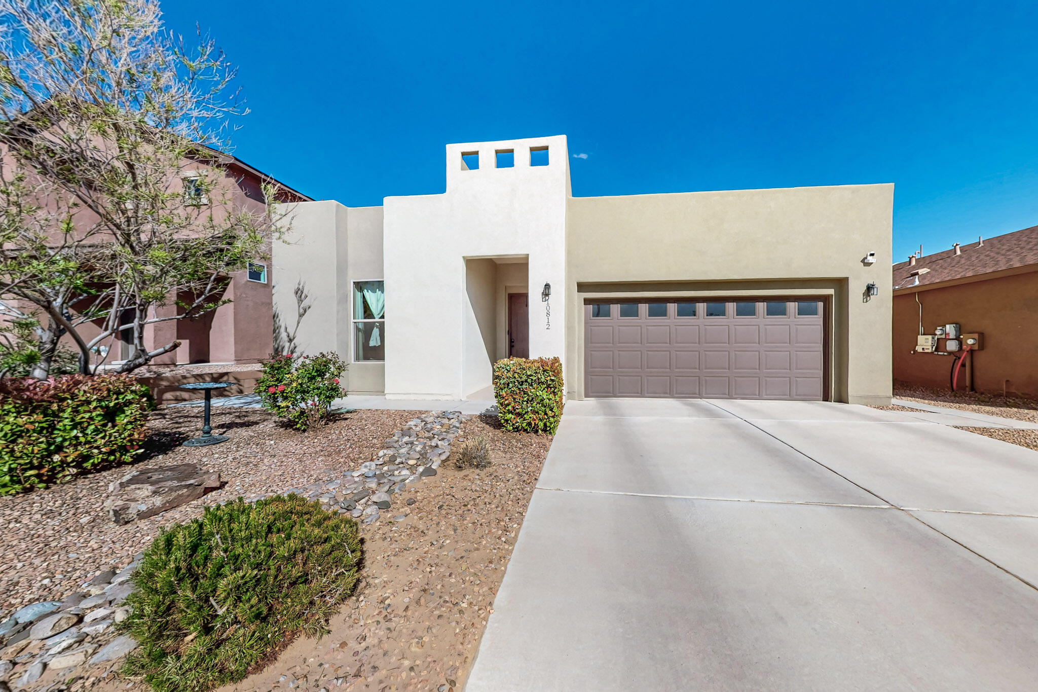 Must see stunning Raylee Contemporary Home in Northwest Albuquerque. The home features 3 bedrooms and 2 full baths. Quartz Countertops with beautiful Charcoal Cabinetry in the kitchen and island. Tile floors are laid in a staggered pattern in the living areas, and there are recently installed vinyl wood floors in each bedroom. Additional features include tile kitchen backsplash, tiled bathrooms with cultured marble and Charcoal Cabinetry. Step into your private backyard oasis featuring a covered patio that faces east, leading to cooler, shaded summers. Beautifully landscaped with grass, custom raised flowerbed with custom-made sandstone caps, and a fountain. The home contains a tankless water heater, refrigerated air, & has had regular maintenance. This gorgeous home is move-in ready!!!